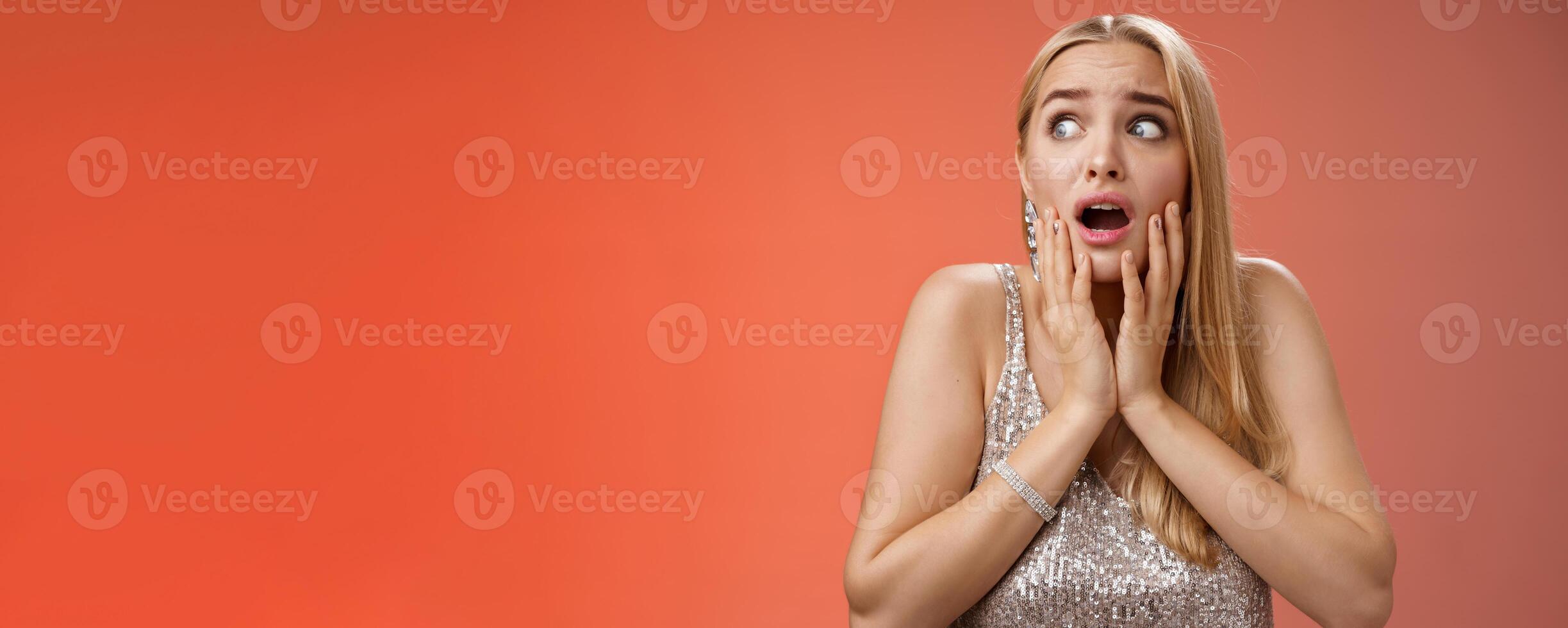 Afraid girl panic look left scared trembling fear insecure touching cheeks helpless stare sideways grimacing gasping frightened nervously waiting help, standing concerned red background photo