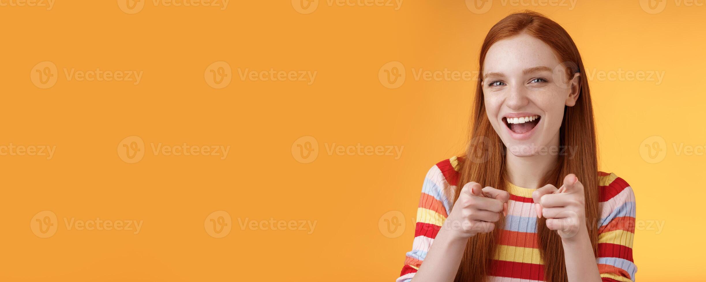 Enthusiastic carefree friendly redhead girl pointing finger-pistols camera smiling joyfully congratulating friend awesome choice cheeky greeting hinting girlfriend caught good opportunity photo
