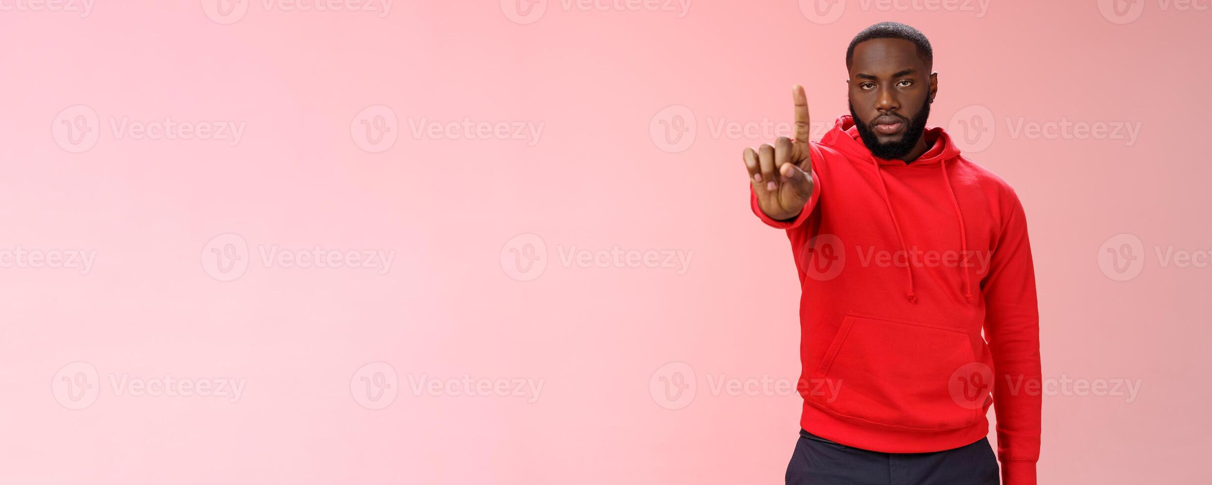 Wait second. Serious-looking annoyed strong brutal african american older brother show index finger number one explaining important rule look bossy solid, standing pink background forbid something photo