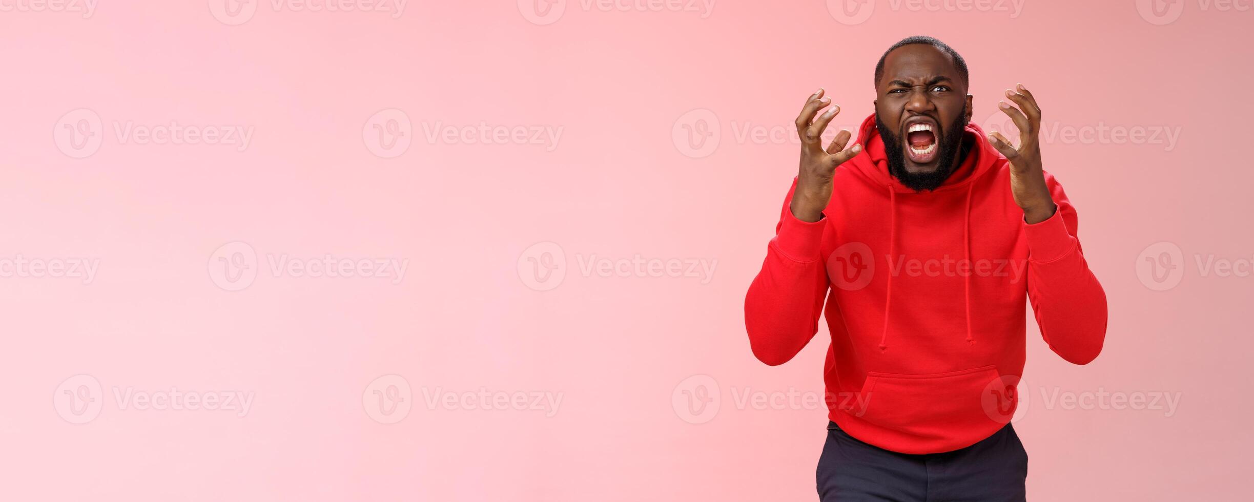 Guy hates subway. Irritated hungry mad bearded african-american man yelling squeez fists frowning grimacing shouting losing temper furiously staring camera go crazy insane, standing pink background photo