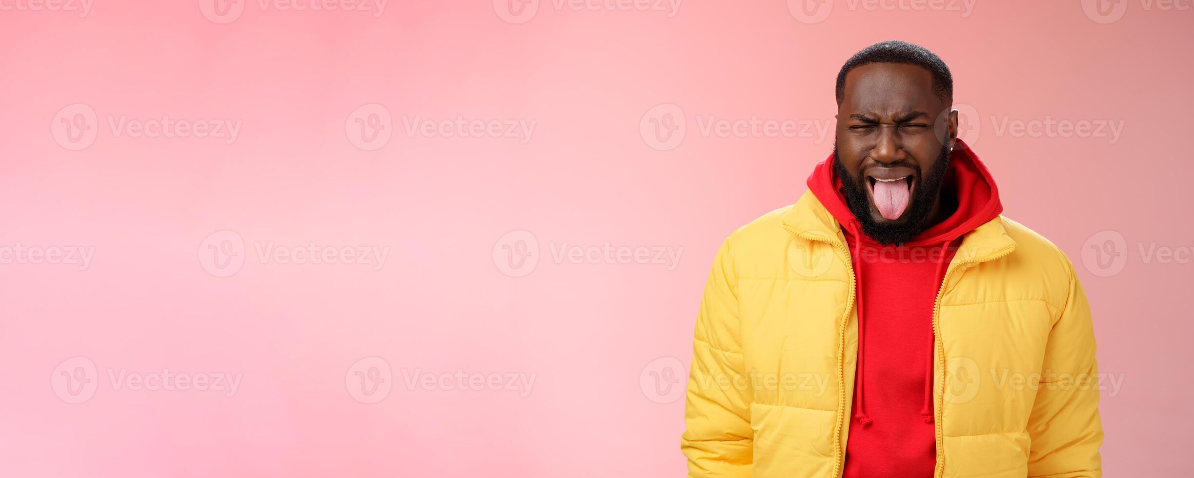 Guy cringing stick burn tongue frowning bothered sip very hot coffee grimcaing aversion dislike expressing childish attitude disliking unwilling go meet girlfriend parents, standing pink background photo