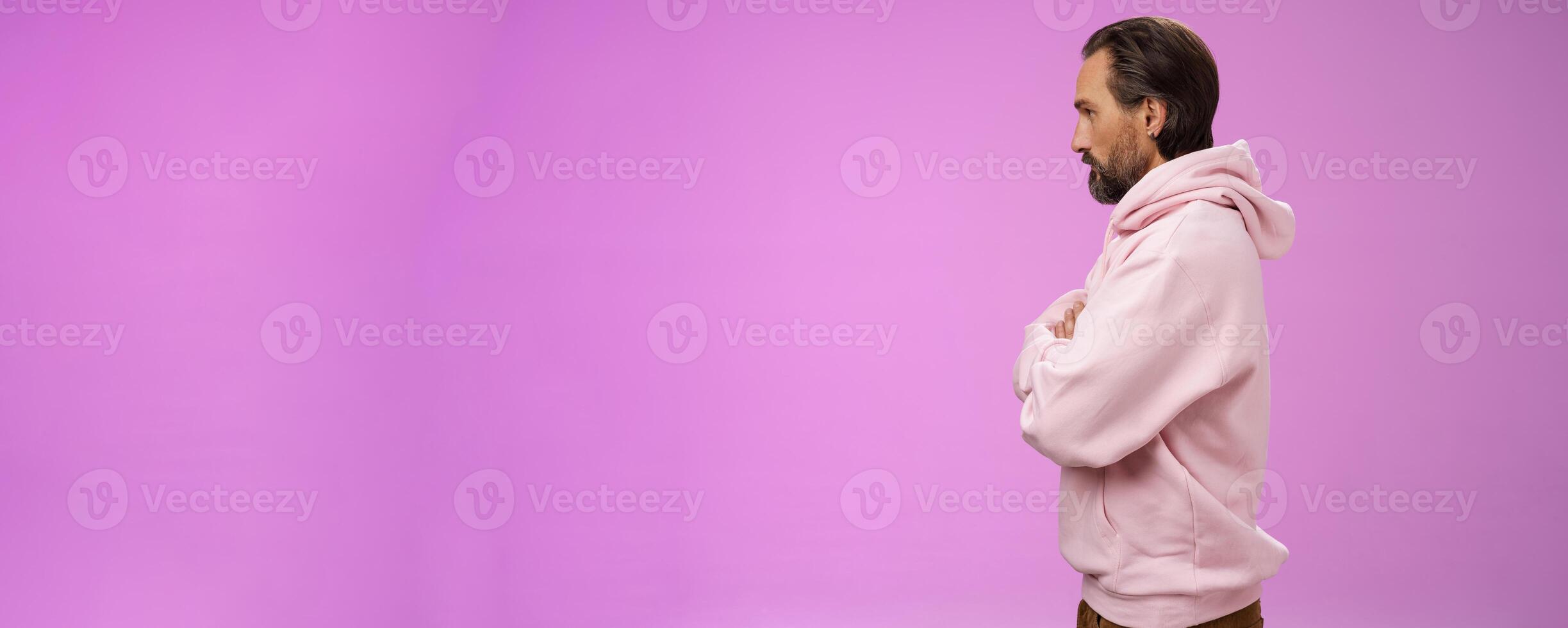 Profile shot serious-looking confident closed defensive adult bearded 40s guy cross arms chest look left impatient irritated standing purple background bothered waiting queue concerned photo