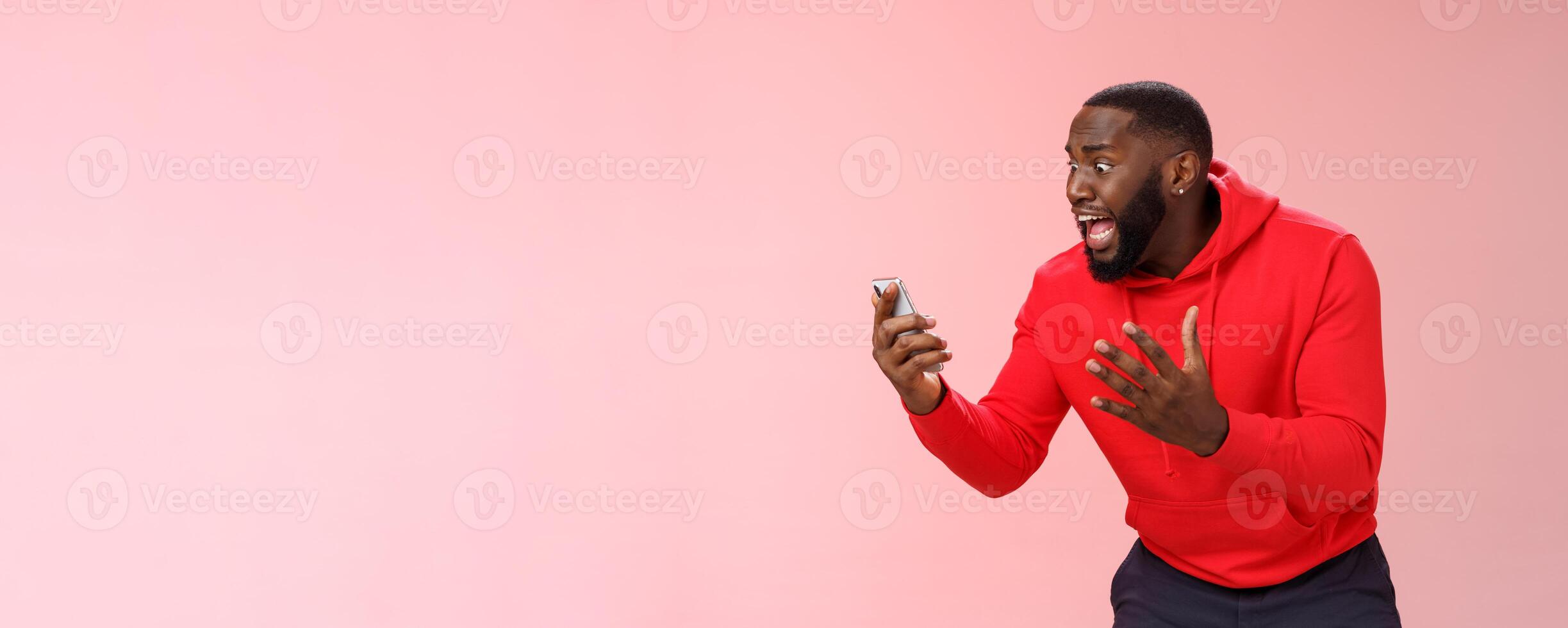 Desparate angry pissed african-american irritated man yelling smartphone look angry phone display gesturing dismay anger, furious lose last level hard game, standing bothered outraged photo