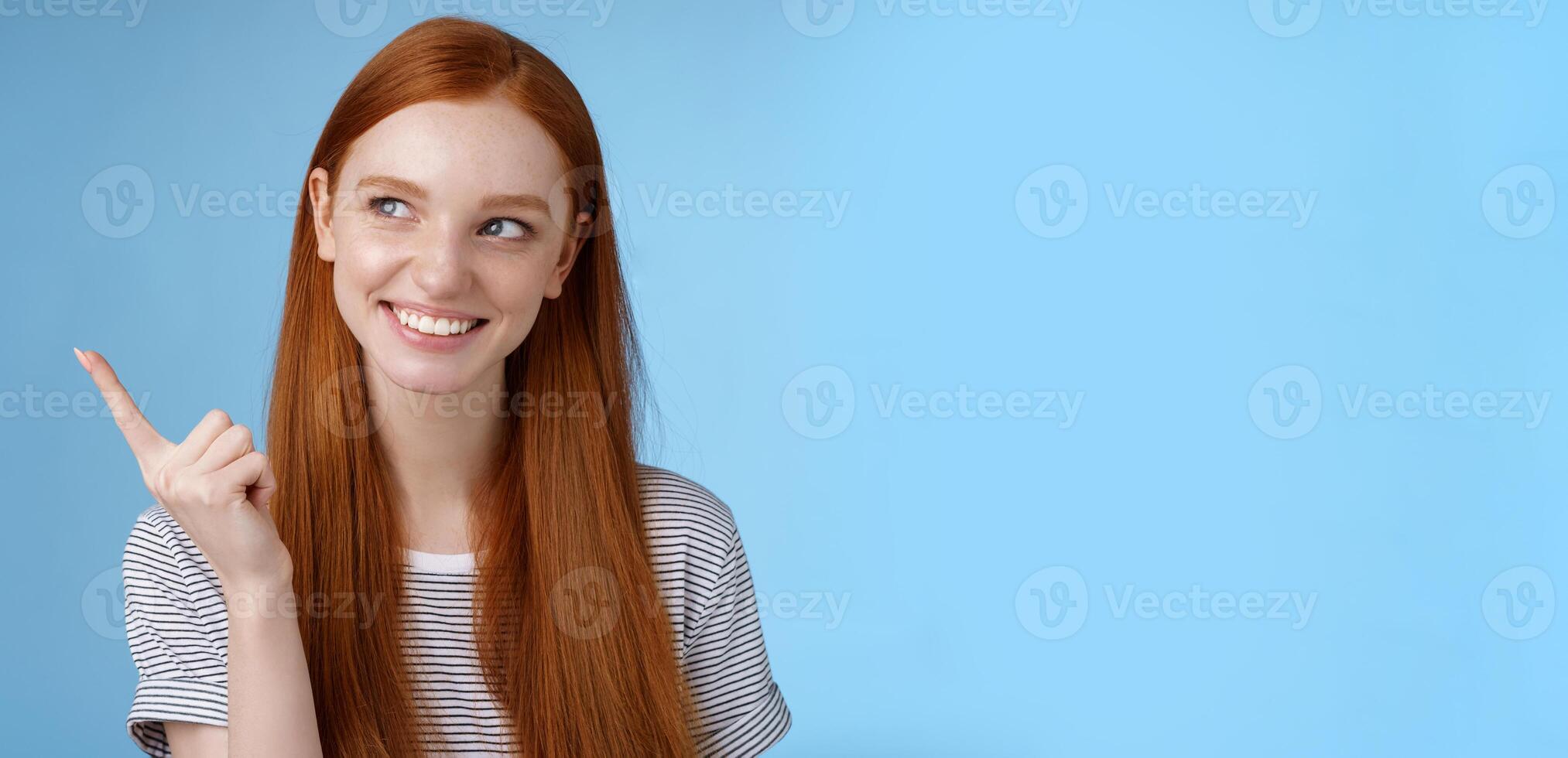 Wow interesting. Curious attractive smiling young 20s female student find good offer price product look pointing upper left corner intrigued grinning satisfied have perfect idea how use copy space photo