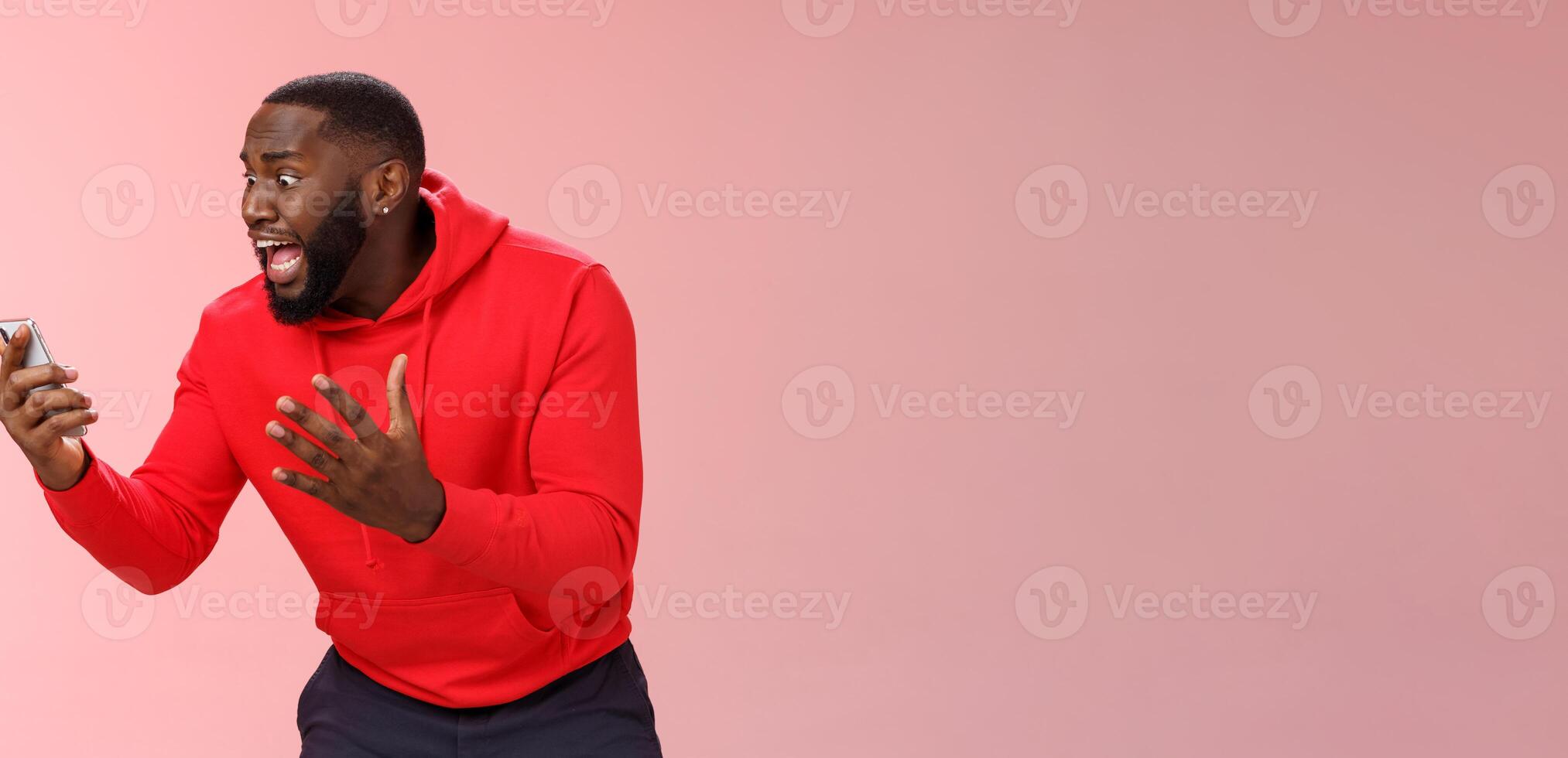 Desparate angry pissed african-american irritated man yelling smartphone look angry phone display gesturing dismay anger, furious lose last level hard game, standing bothered outraged photo