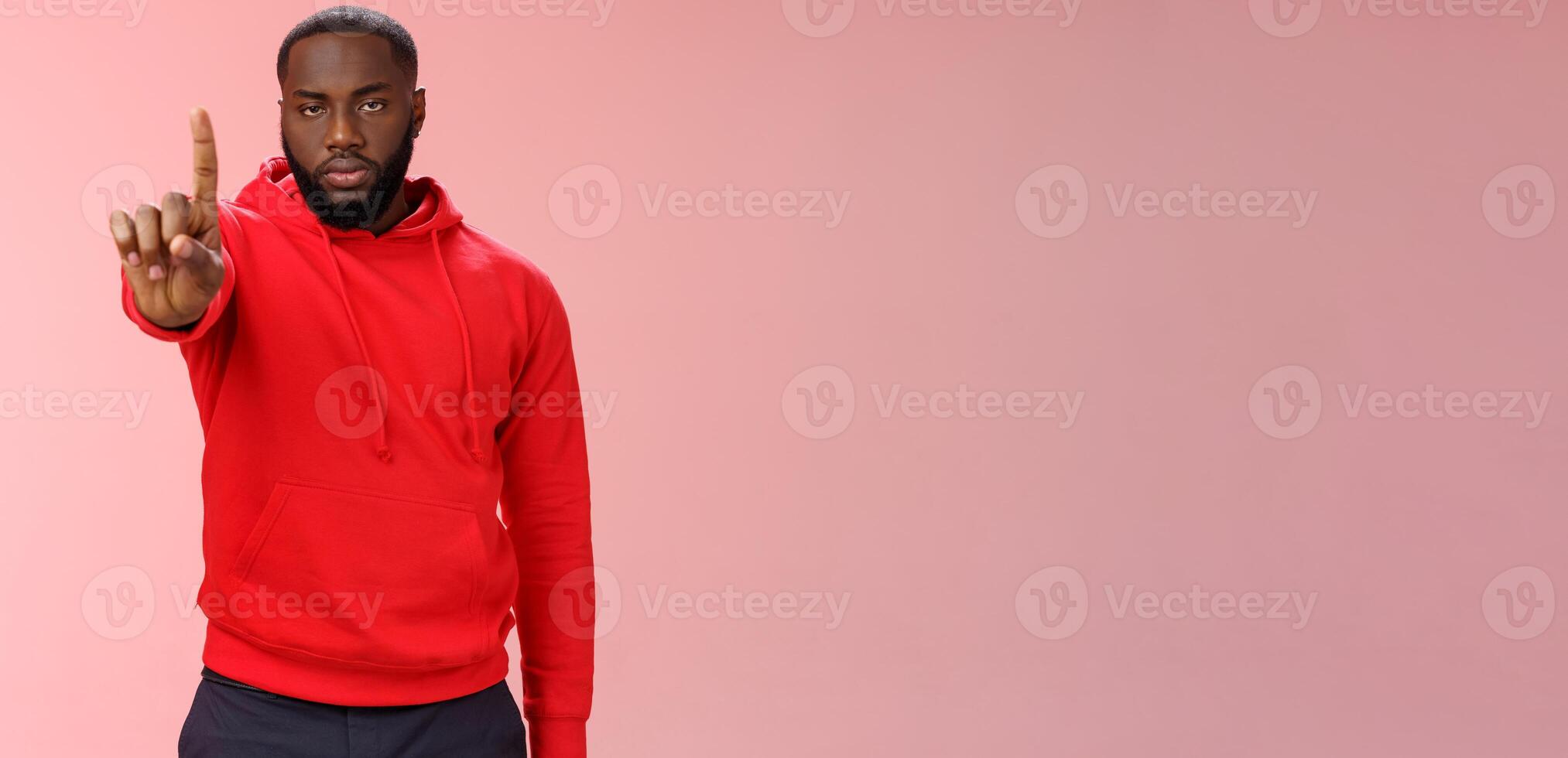 Wait second. Serious-looking annoyed strong brutal african american older brother show index finger number one explaining important rule look bossy solid, standing pink background forbid something photo