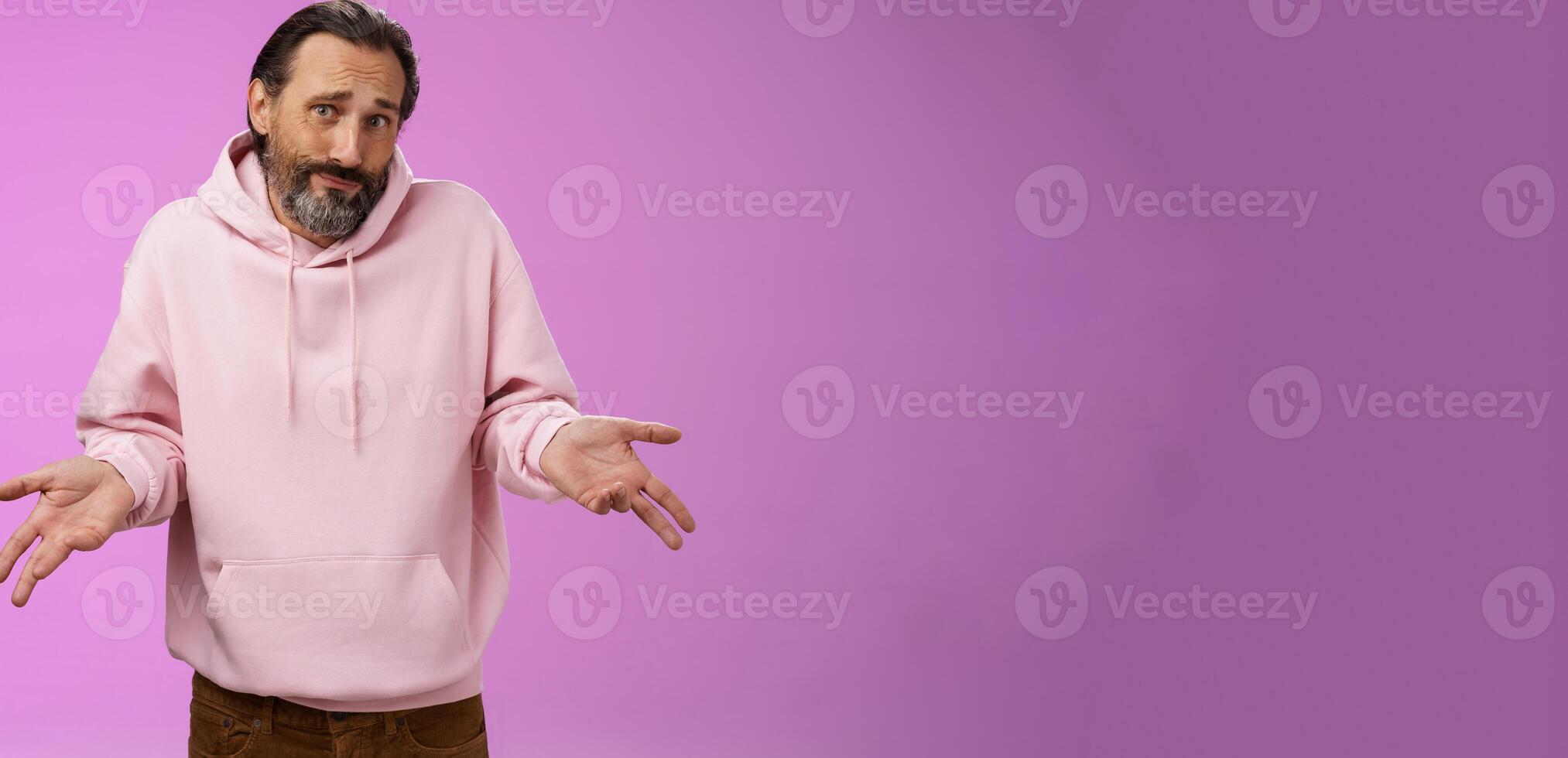 Portrait clueless unaware father cringing smirking uncertain shrugging hands spread sideways no idea, look questioned doubtful cannot answer unknown topic, standing purple background photo