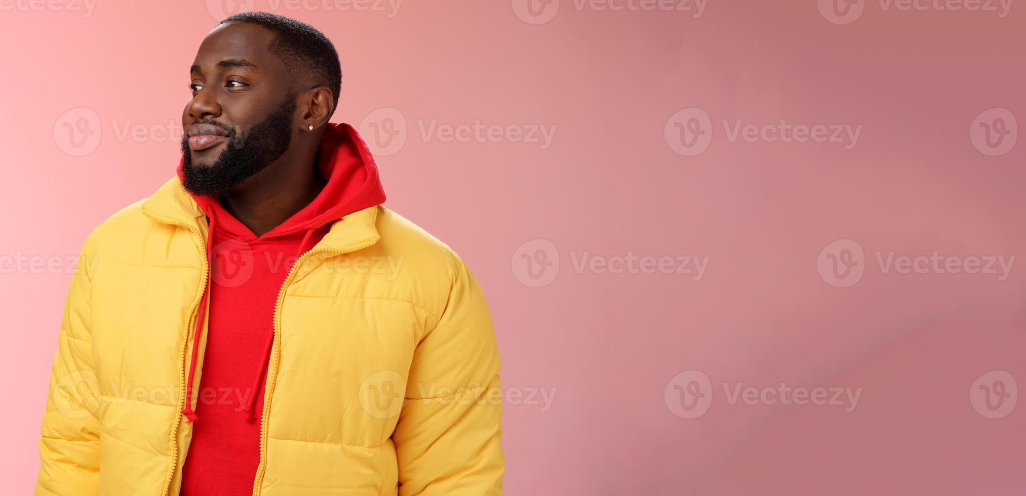 Dreamy happy optimistic black bearded man looking left daydreaming recalling nice moments, enjoying warm peaceful weather walking park feel calm relieved, standing pink background smiling cute photo