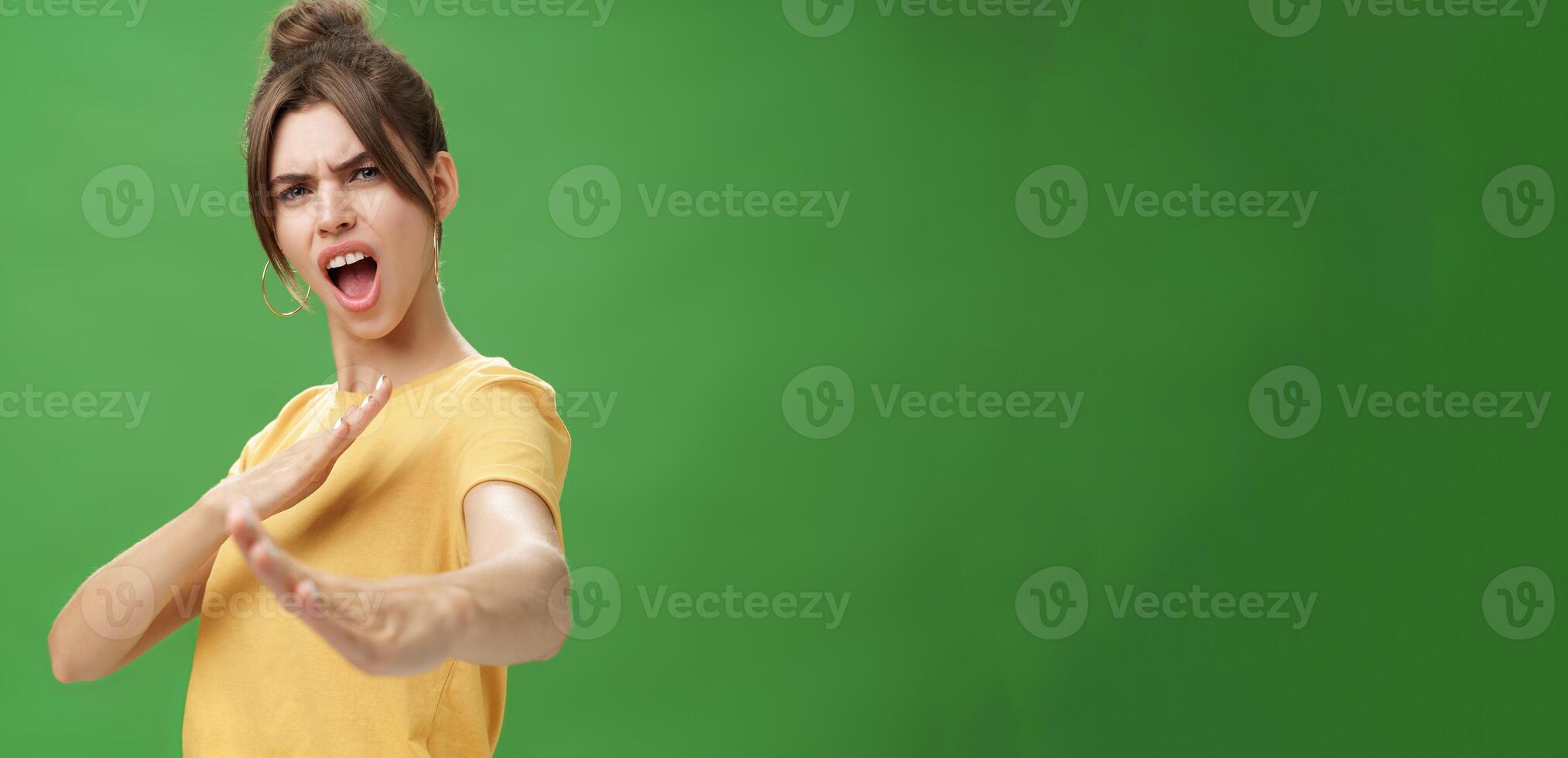 Not mess with this girl. Portrait of funny and emotive charismatic young woman standing in martial arts pose, showing fighting skills yelling kiya, open mouth frowning making karate movements photo