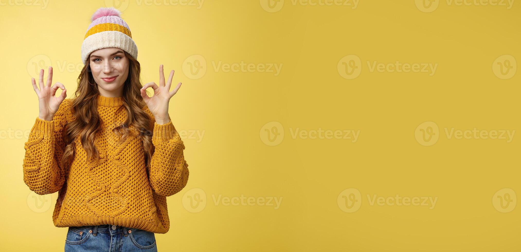 You look awesome. Portrait satisfied good-looking girl show okay gesture delighted good result, excellent perfect work, assuring no problem, smiling devious check out cool shot, yellow background photo