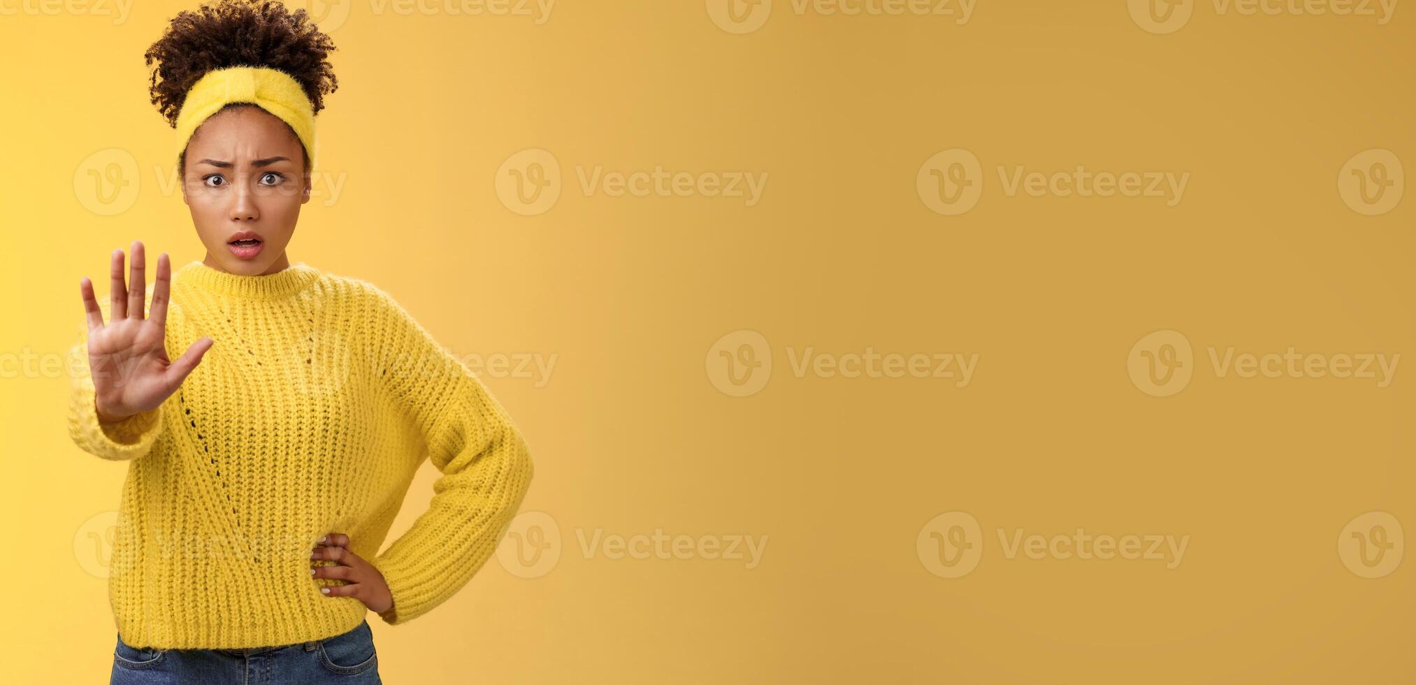 Afraid shocked insecure woman trying show voice be brave extend arm enough stop refusal gesture look frightened insecure unconfident rejecting declining offensive proposal, yellow background photo