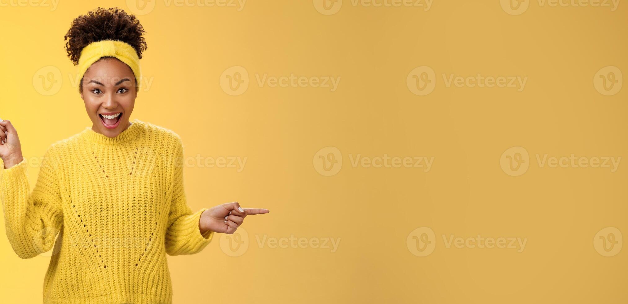 Energized active charismatic african-american woman afro hairstyle in sweater headband screaming fascinated enthusiastic pointing left right impressed variaty awesome choices, picking products photo