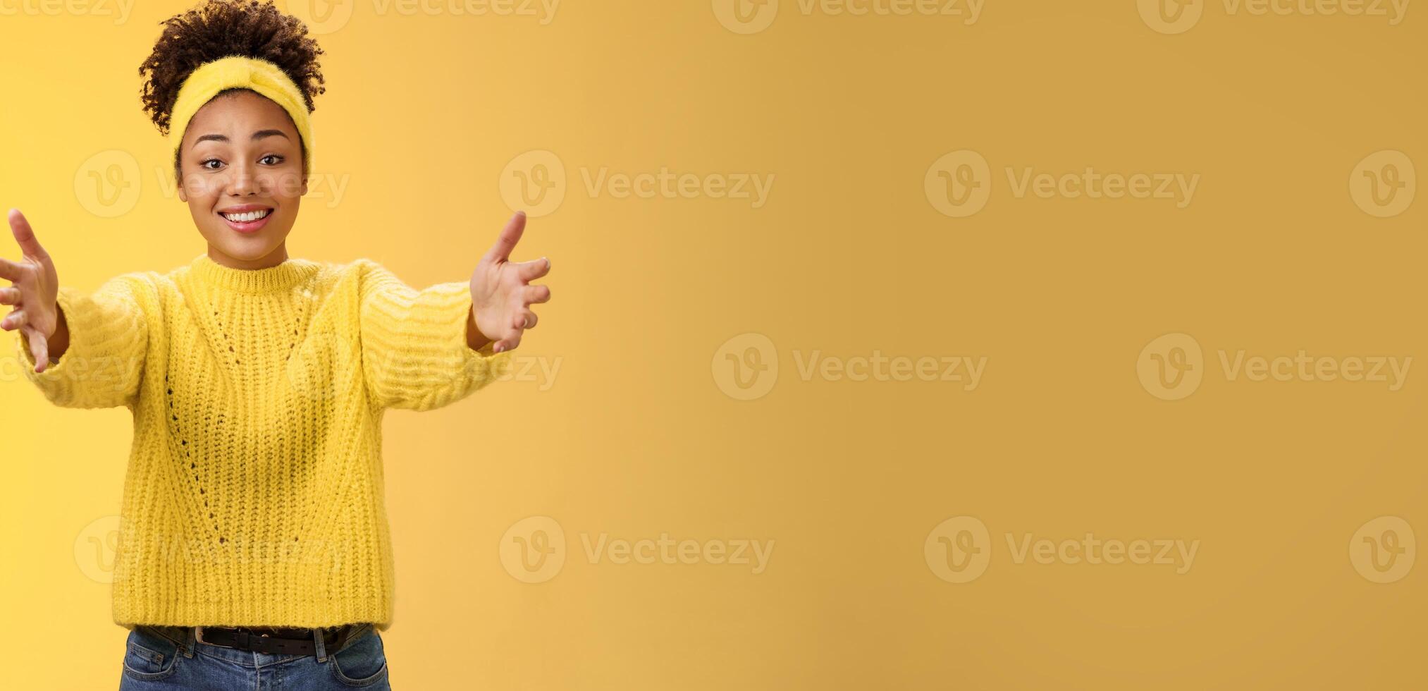 Come closer let me hug you. Touched lovely glad african-american young pretty woman extend arms wanna hold charming cute baby arms asking cuddle embrace friendly, posing yellow background photo
