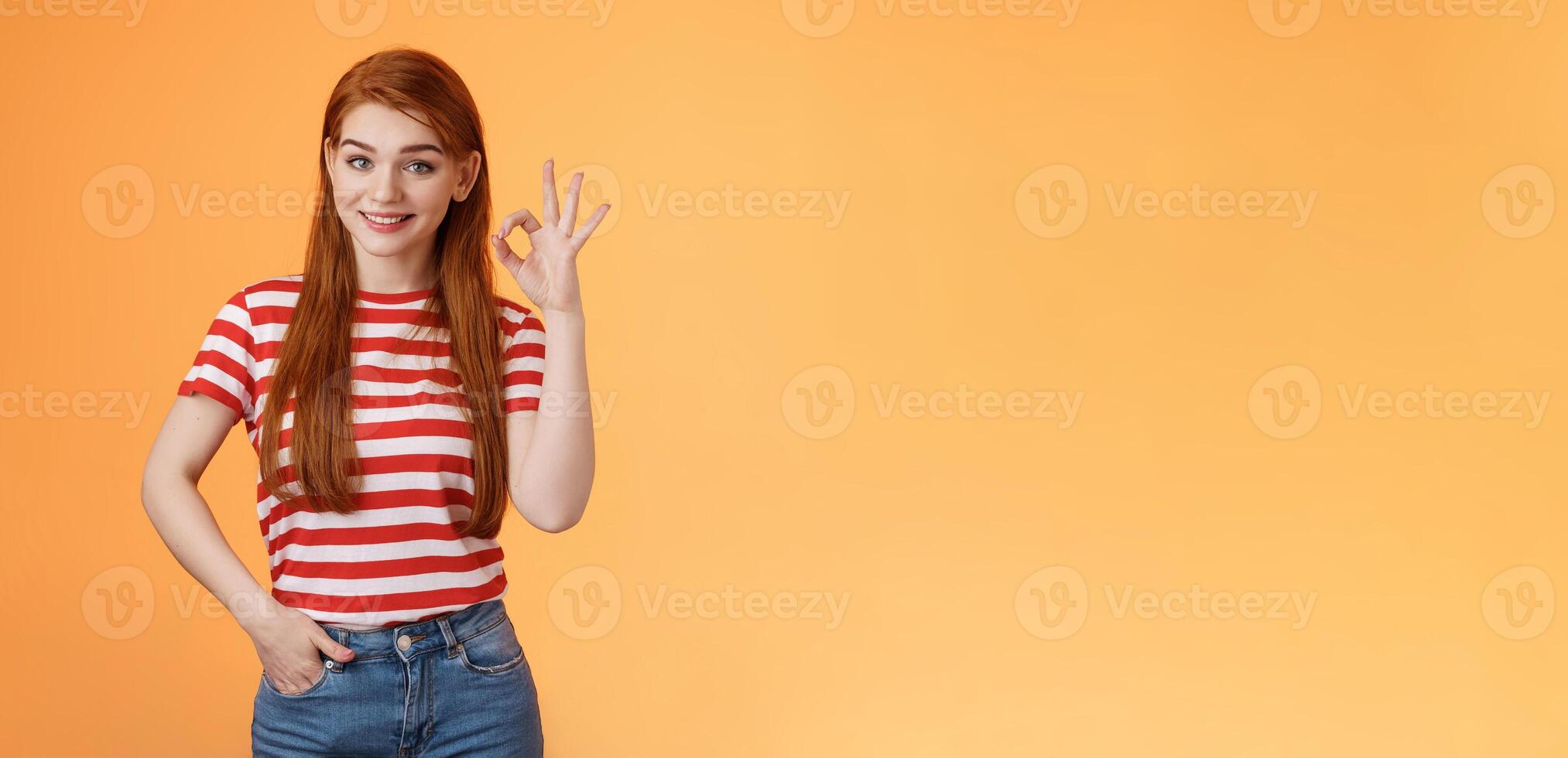 Very good. Pleased cute female showing okay sign and smiling satisfied, grinning delighted recieve positive result, hold hand pocket assertive, self-assured pose, agree, accept terms, recommend photo