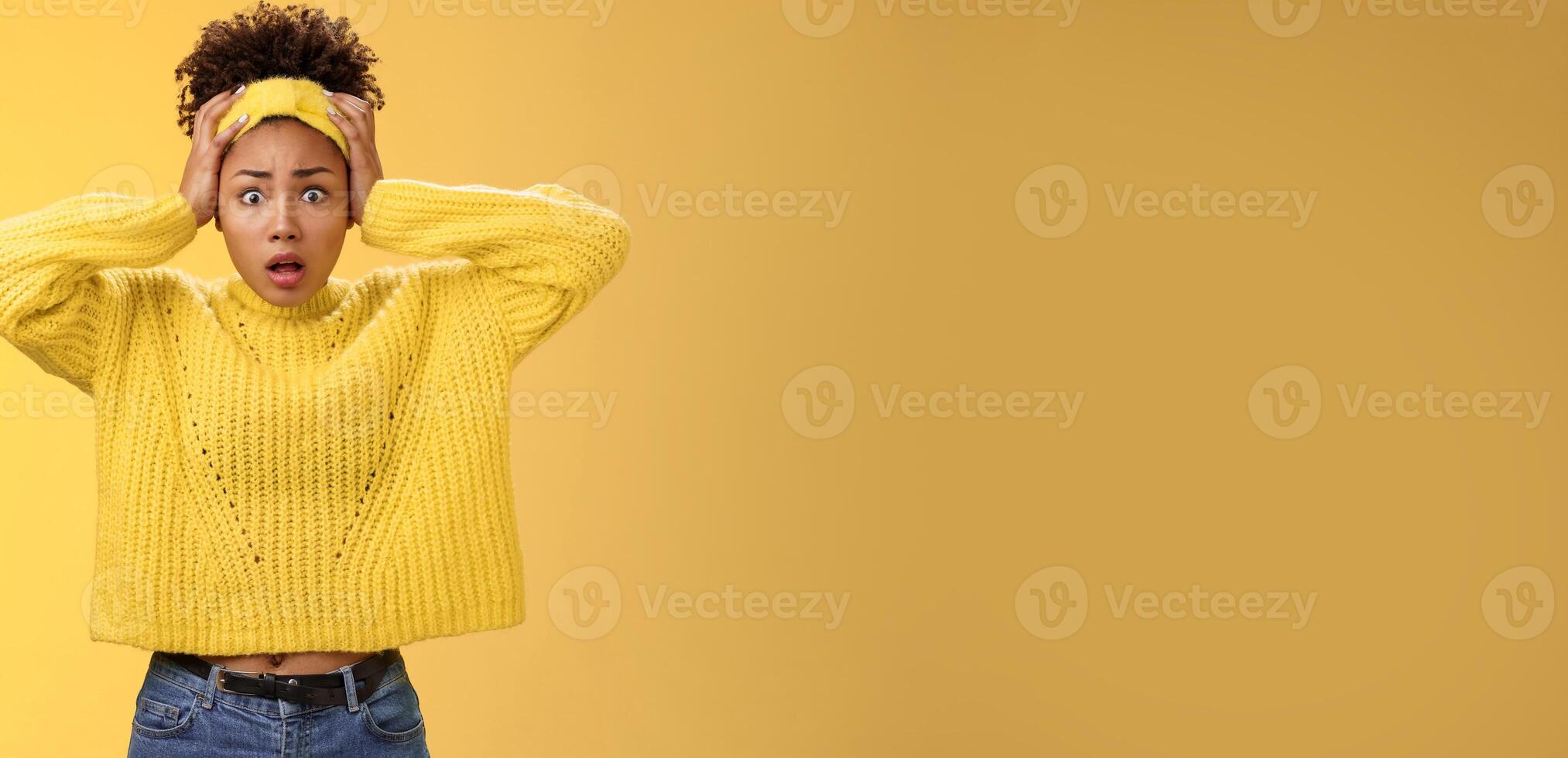 Troubled concerned perplexed female african-american employee duty look complicated panic hold hands head widen eyes shocked face troubles nervously thinking look anxious camera, yellow background photo