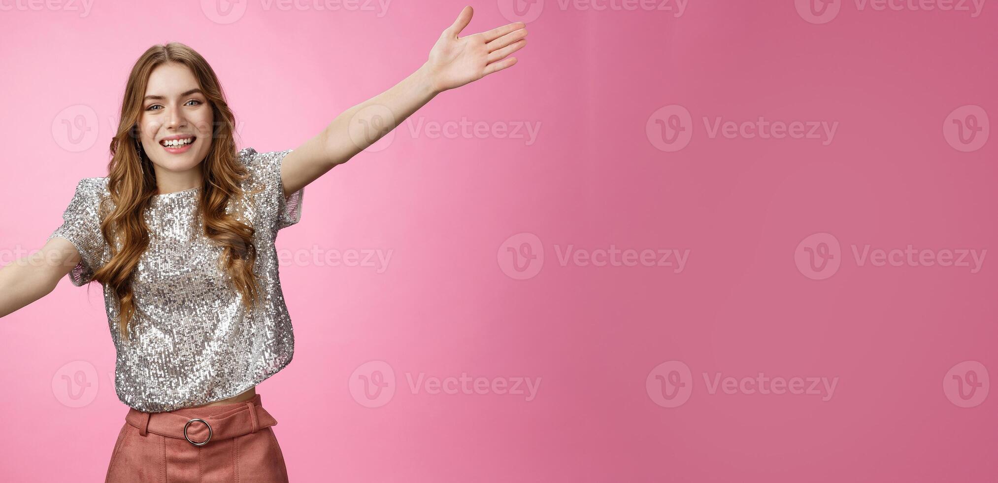 Come into my arms. Portrait friendly outgoing charming cute caucasian female wearing glittering blouse extend arms sideways wanna embrace cuddle friend welcoming hugging guests, smiling broadly photo