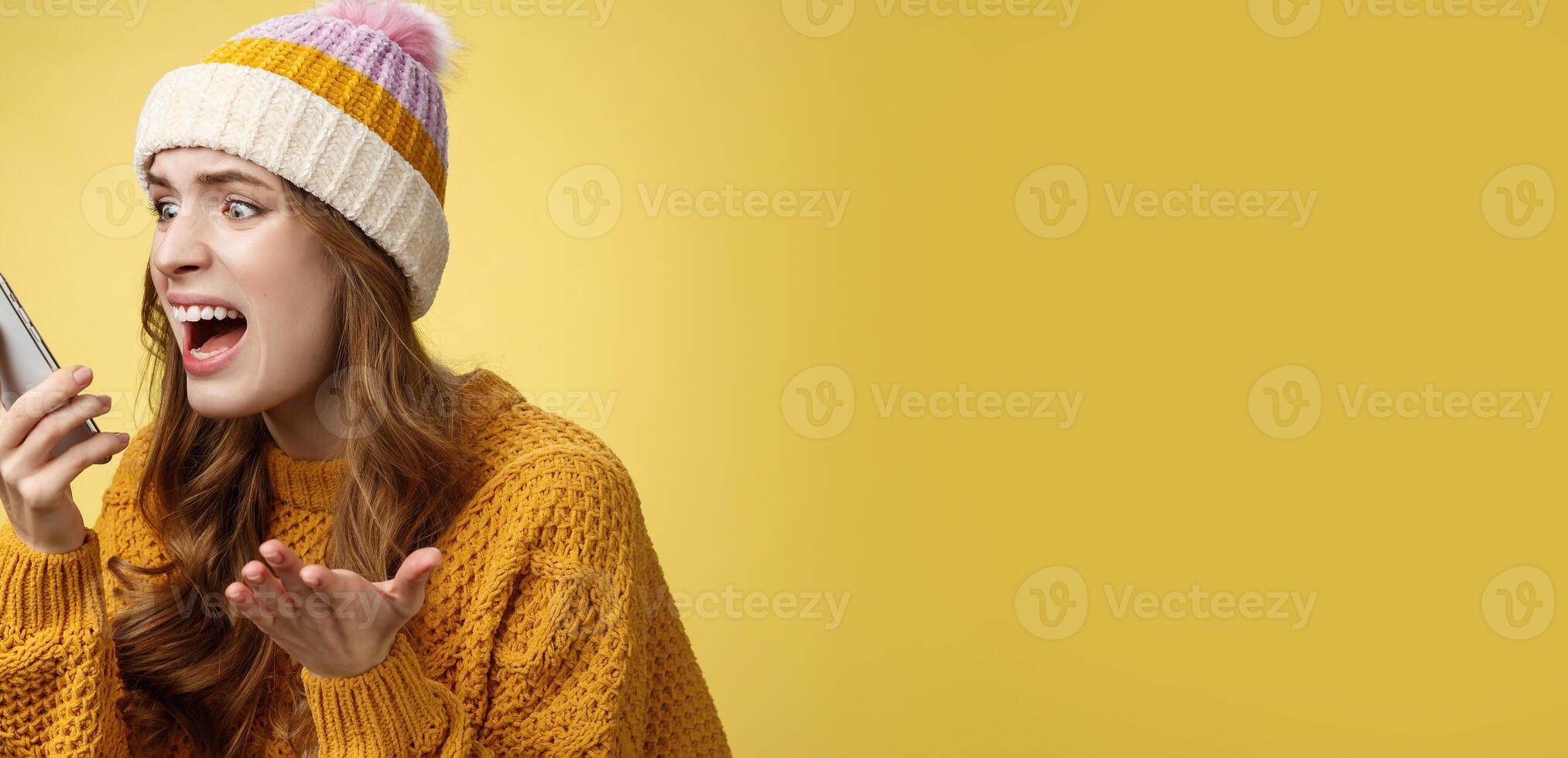 Annoyed pissed freak-out crazy woman shouting smartphone look display near face irritated arguing boyfriend breaking-up via phone call standing angry furiously yelling cellphone, raise hand dismay photo
