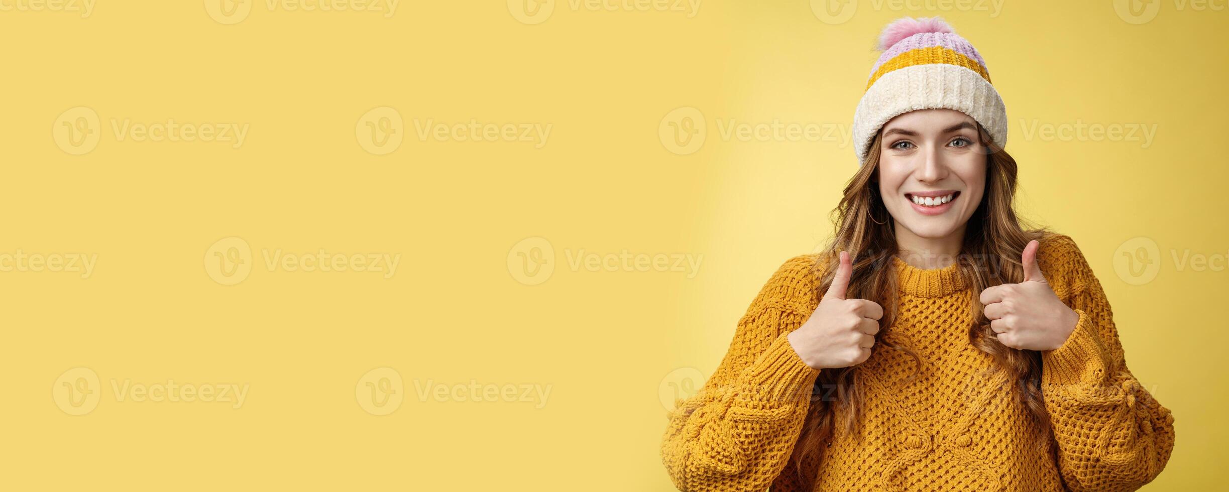 Close-up charming supportive kind young woman show thumbs-up gesture smiling approval liking your idea encourage keep up, satisfied good excellent choice, standing pleased yellow background photo