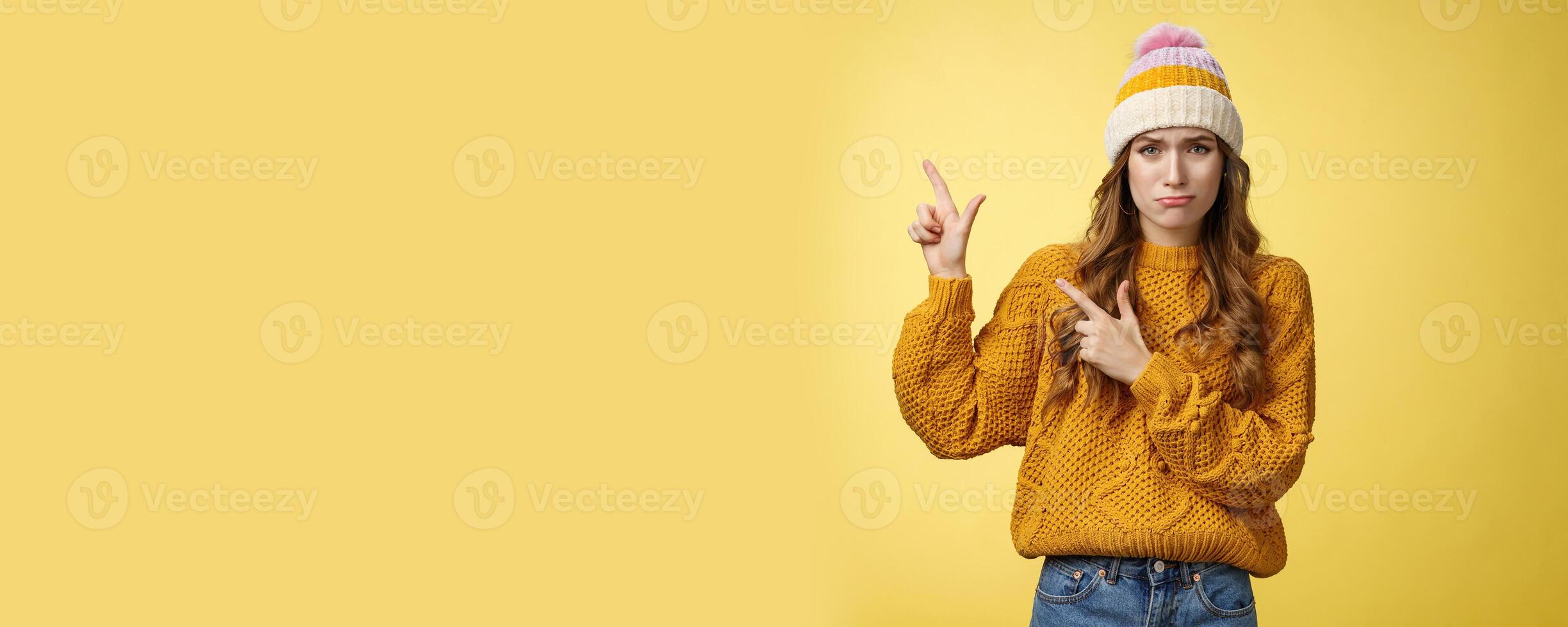 Timid insecure sobbing cute girlfriend offended pointing bad guy show left side whining lip trembling complaining was insulted, standing upset crying miserable, posing yellow background photo