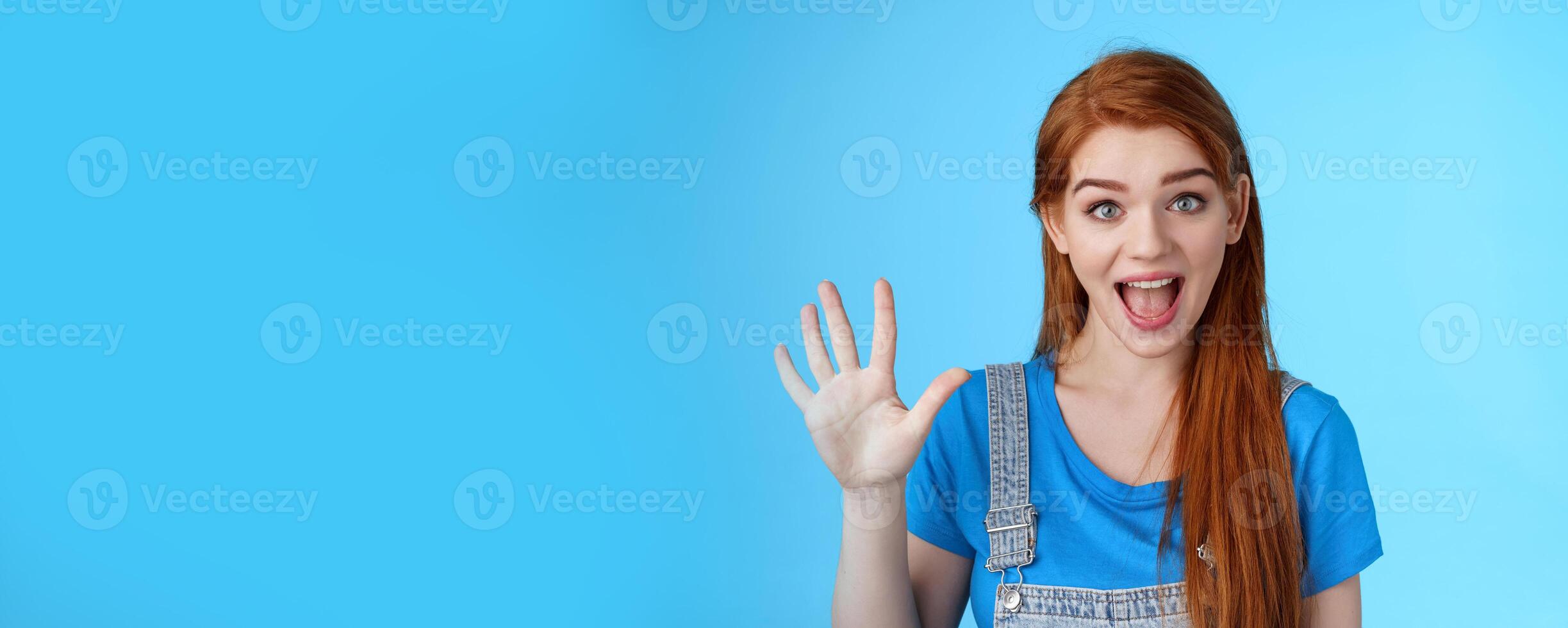 Cheerful amused redhead woman long natural red hairstyle show number five fifth, make order, counting fingers, smiling broadly, talking amused, count down, stand blue background joyful photo
