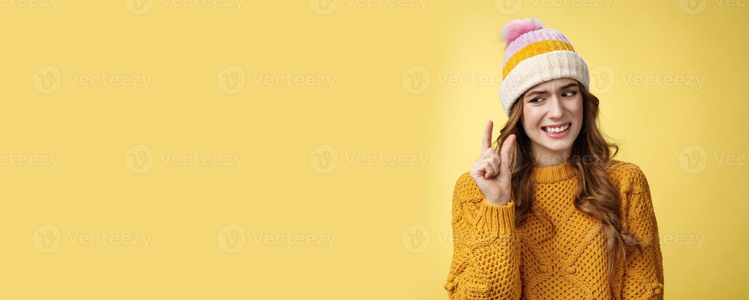 Displeased attractive picky woman describing small object show tiny thing cringing dislike disappointment look upset fingers, describing little salary new job, standing yellow background awkward photo