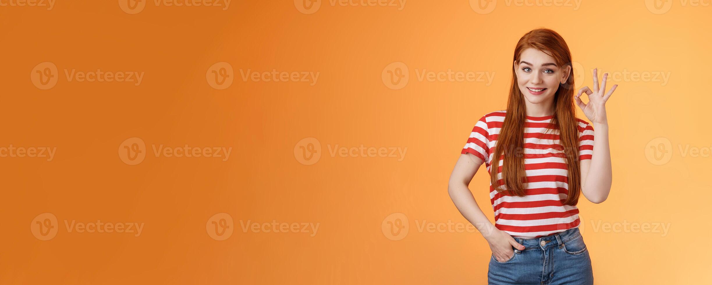 Very good. Pleased cute female showing okay sign and smiling satisfied, grinning delighted recieve positive result, hold hand pocket assertive, self-assured pose, agree, accept terms, recommend photo