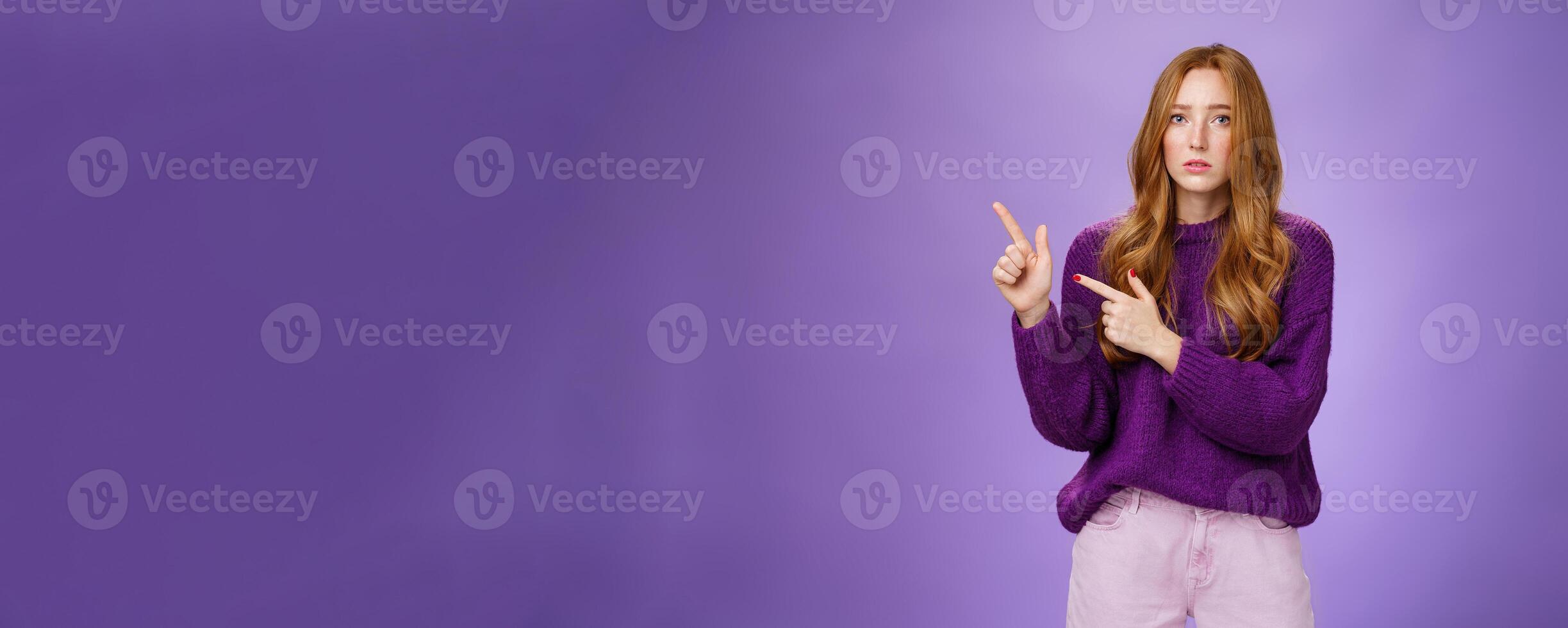 Upset and gloomy woman in sorrow feeling regret of missing huge sales looking reckelss and unhappy pointing questioned at upper left corner with hopeless expression over purple background photo