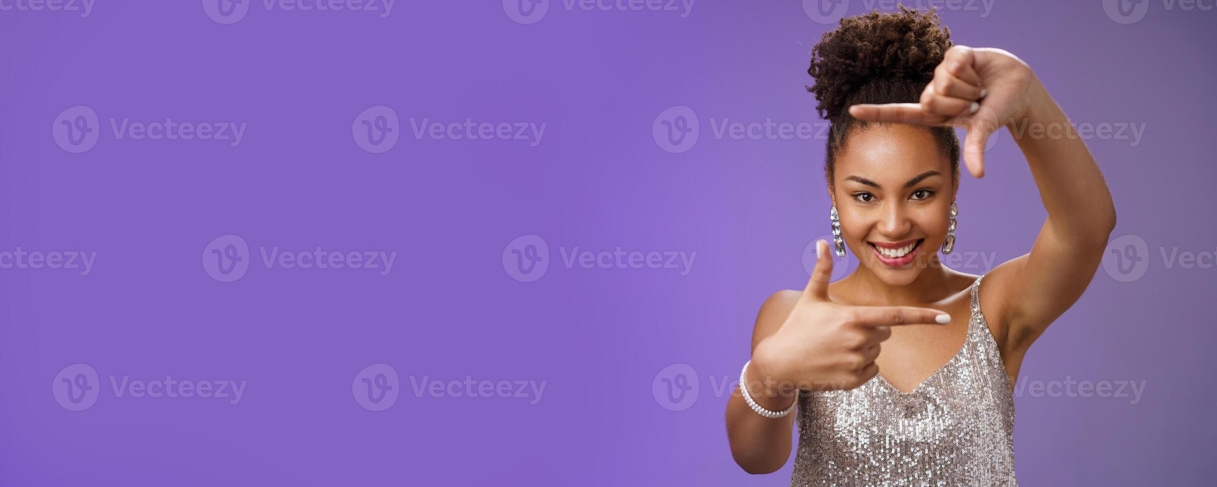 Elegant attractive happy creative african american girl in silver shiny dress make finger frames smiling through it search inspiration looking confident found perfect angle design idea, spot goal photo