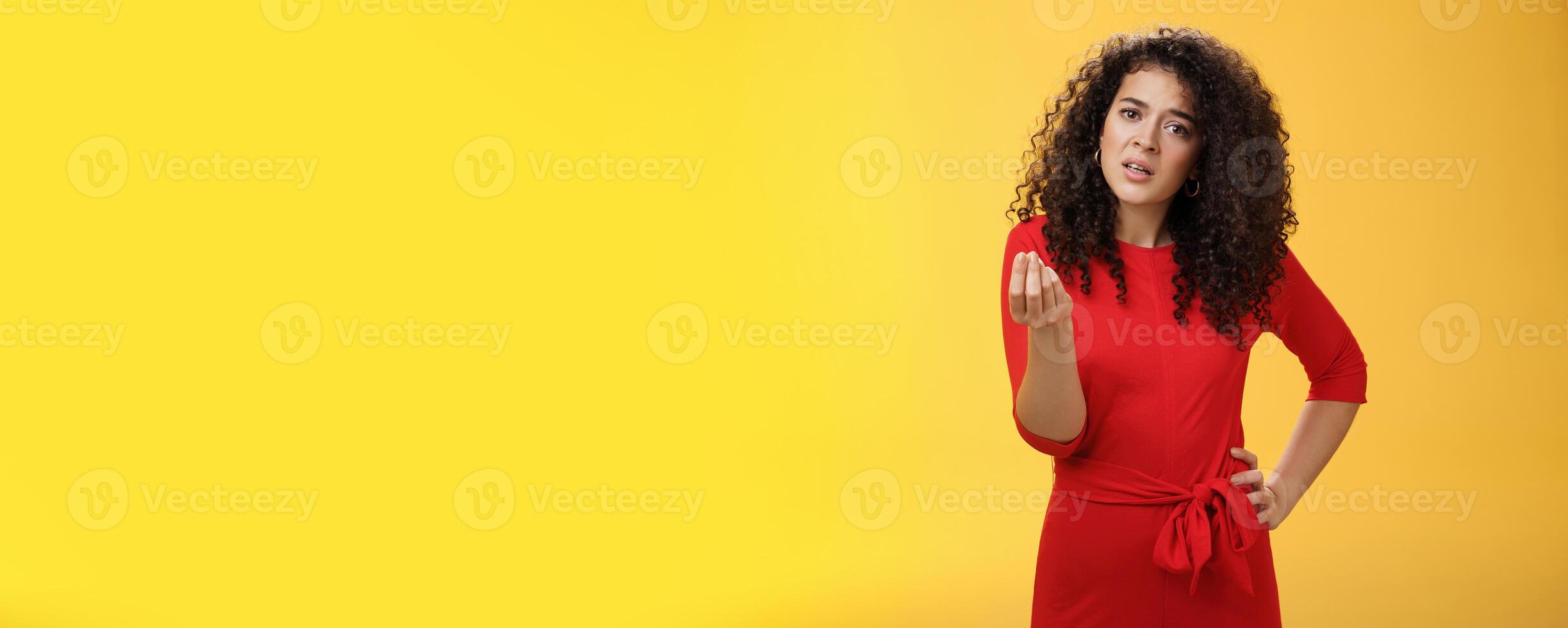 Girl being pissed off arguing ad complaining making italian what do you want gesture looking bothered waiting for explanation as standing annoyed and fed up over yellow background photo