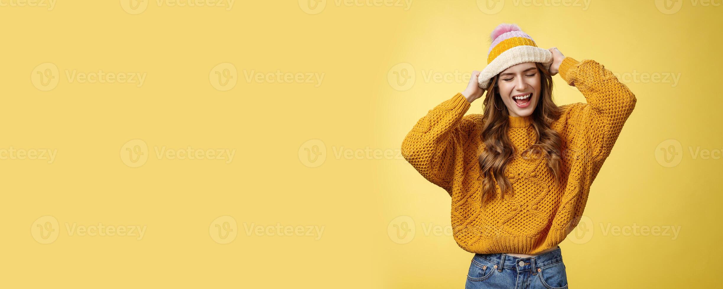 Wild rebellious carefree good-looking stylish caucasian woman having fun screaming out loud careless close eyes touching hat dancing singing favorite music listening songs dress-up university photo