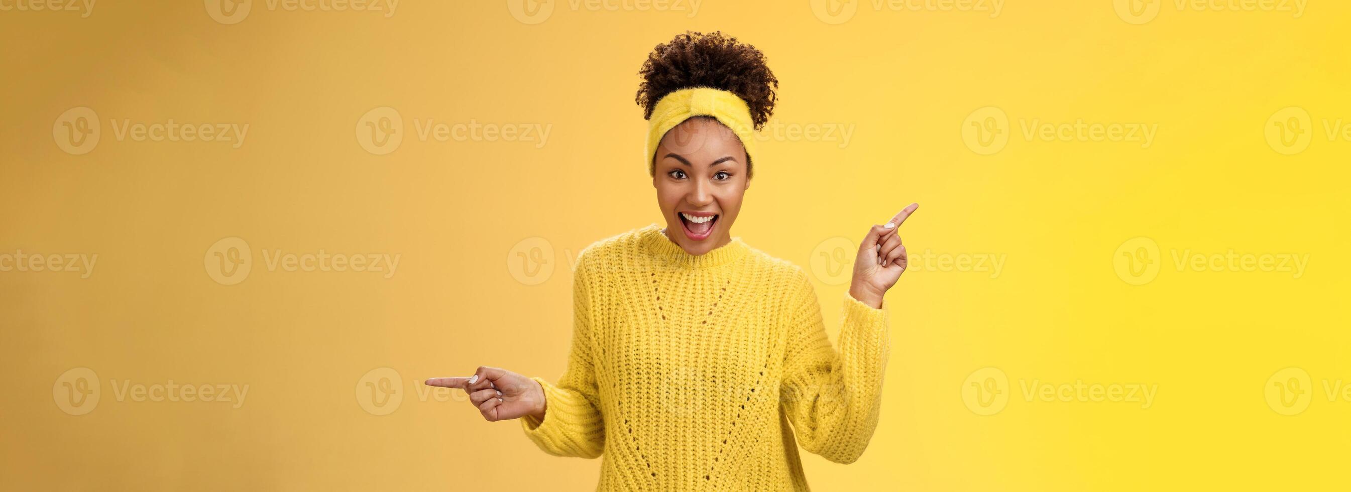 Energized active charismatic african-american woman afro hairstyle in sweater headband screaming fascinated enthusiastic pointing left right impressed variaty awesome choices, picking products photo