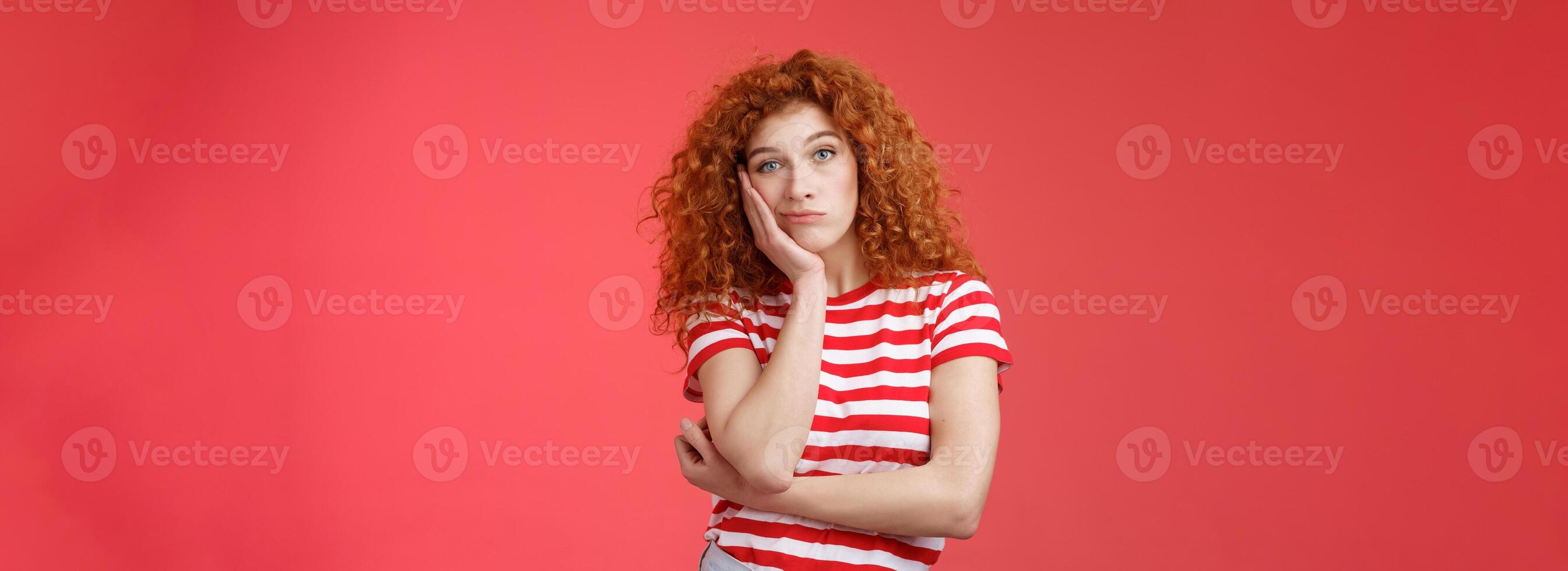Playful redhead gorgeous girl feel sad lacking energizing party lean palm look indifferent express boredom lonely feelings attend boring meeting standing upset reluctant red background photo