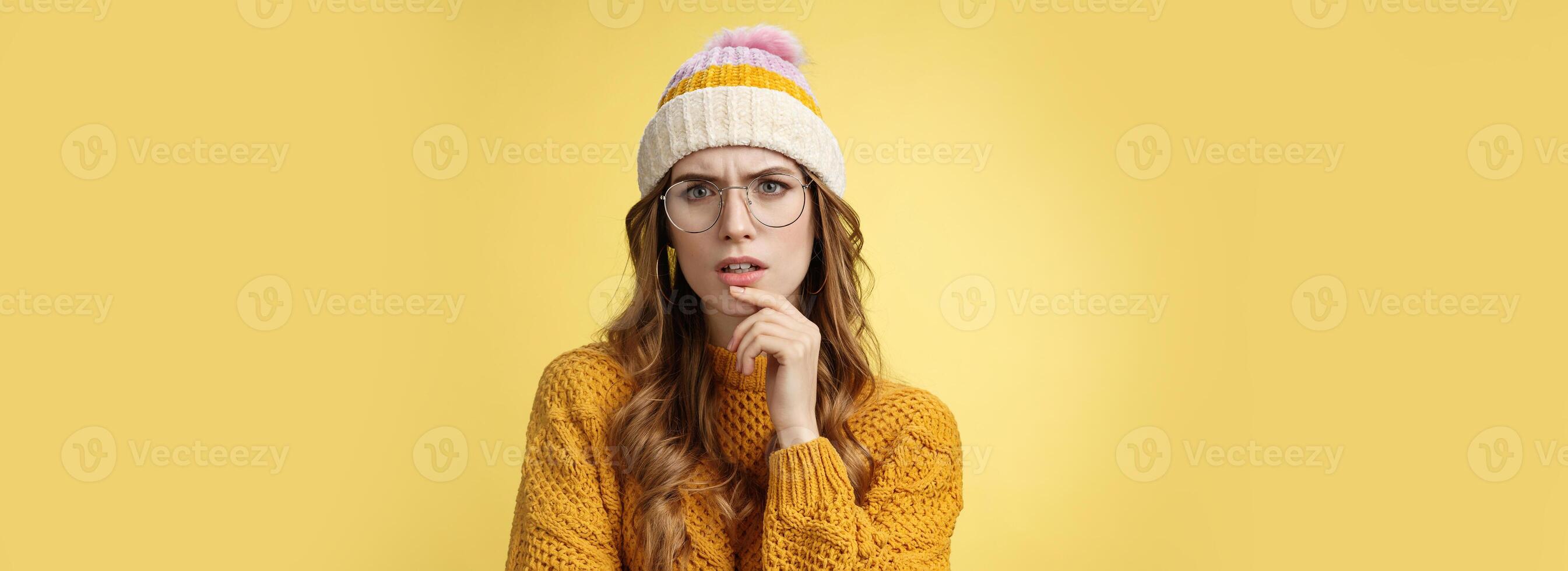 Serious-looking thoughtful smart perplexed woman solving riddle puzzle frowning squinting suspicious doubtful thinking touching face, determined looking problem, standing complicated photo