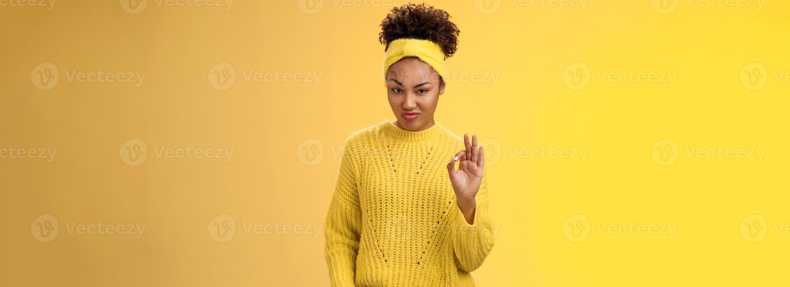 Okay not bad. Portrait devious serious-looking confident african-american bossy girl check out nice work done show ok gesture smug approval agree like good job, standing yellow background pleased photo