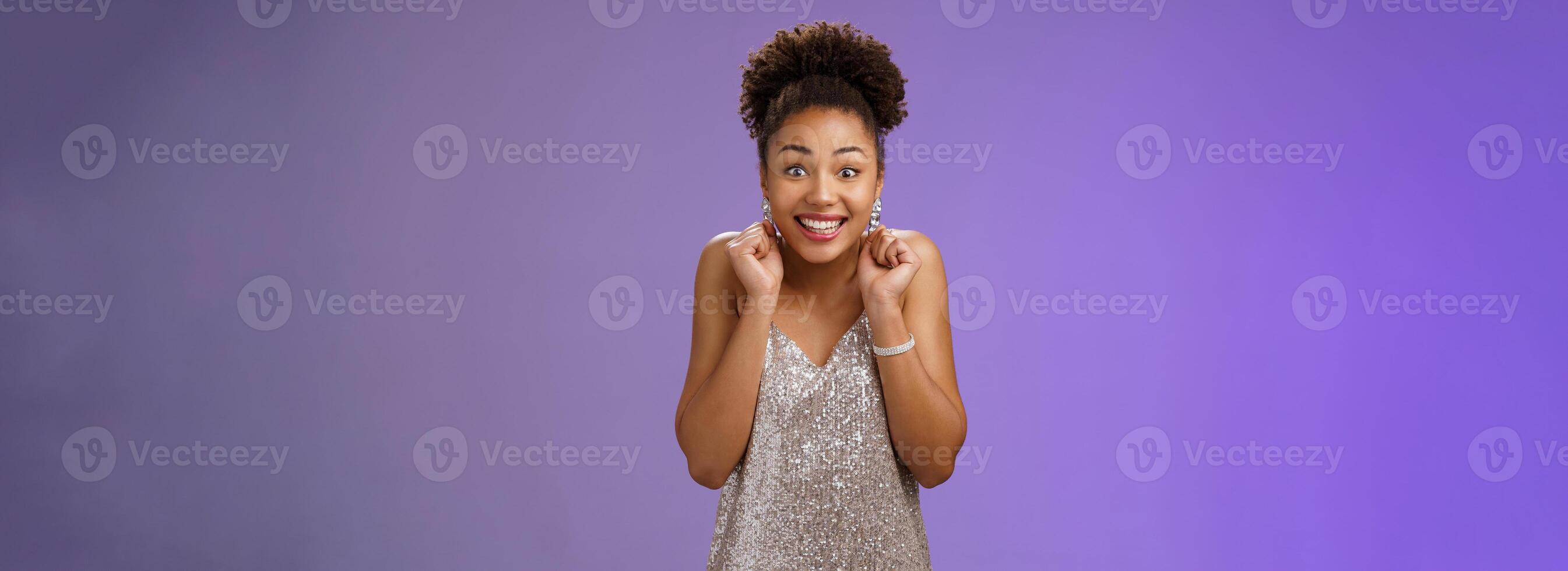 Excited good-looking happy lucky african-american woman winning money lottery casino standing amused thrilled wanna try more smiling broadly dancing clench fists rejoice triumphing photo