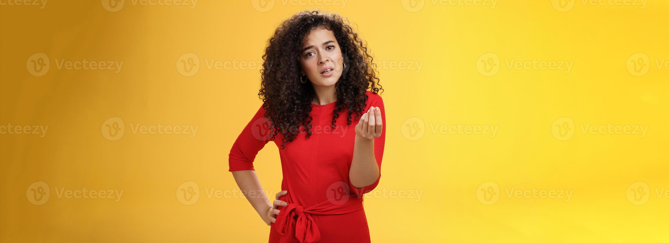 Girl being pissed off arguing ad complaining making italian what do you want gesture looking bothered waiting for explanation as standing annoyed and fed up over yellow background photo