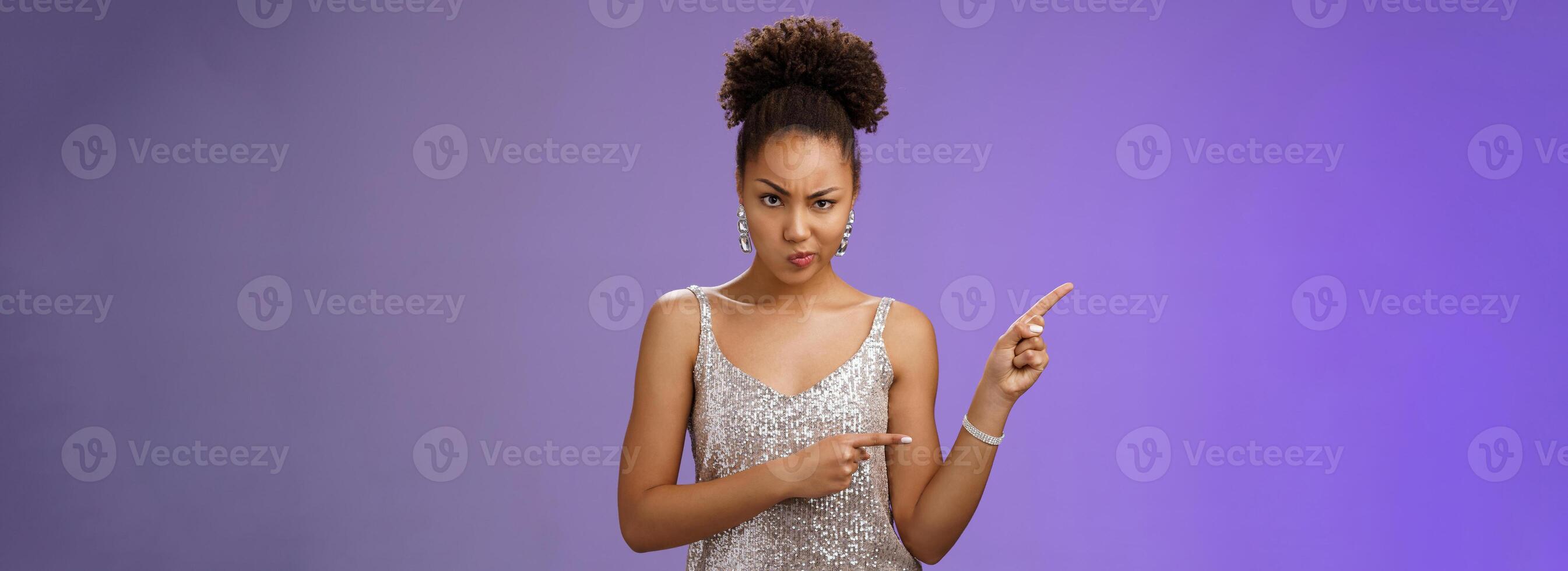 Suspicious intense doubtful unsure elegant smart african-american woman thing something wrong frowning sulking thoughtful express disbelief annoyance pointing upper left uncertain, blue background photo