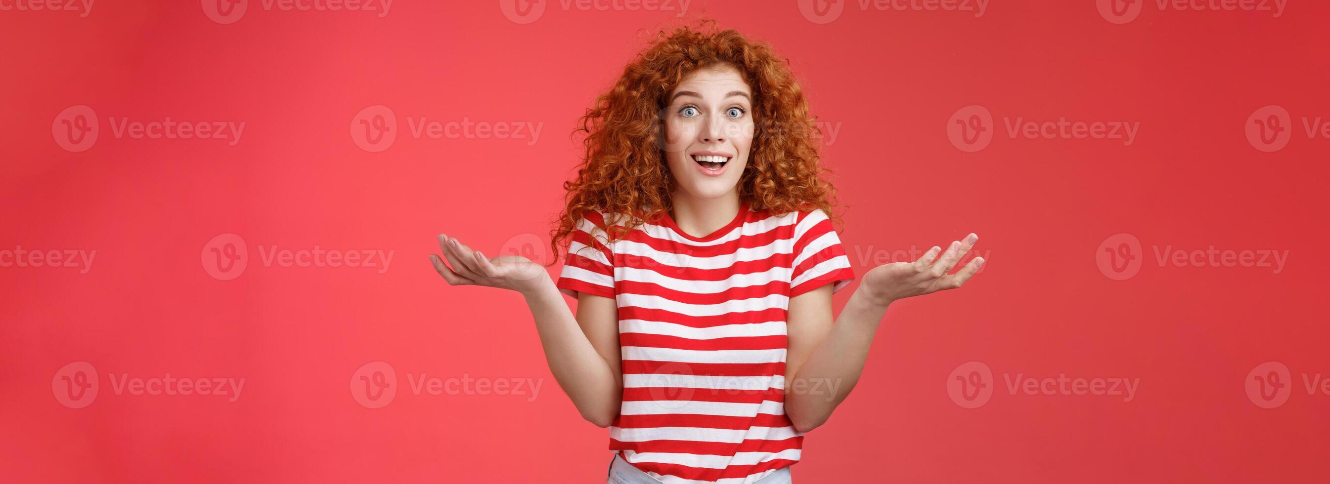 Unaware carefree clueless attractive redhead woman curly hairstyle shrugging unaware hands spread sideways smiling uncertain asking question friend intriguing how she so beautiful photo