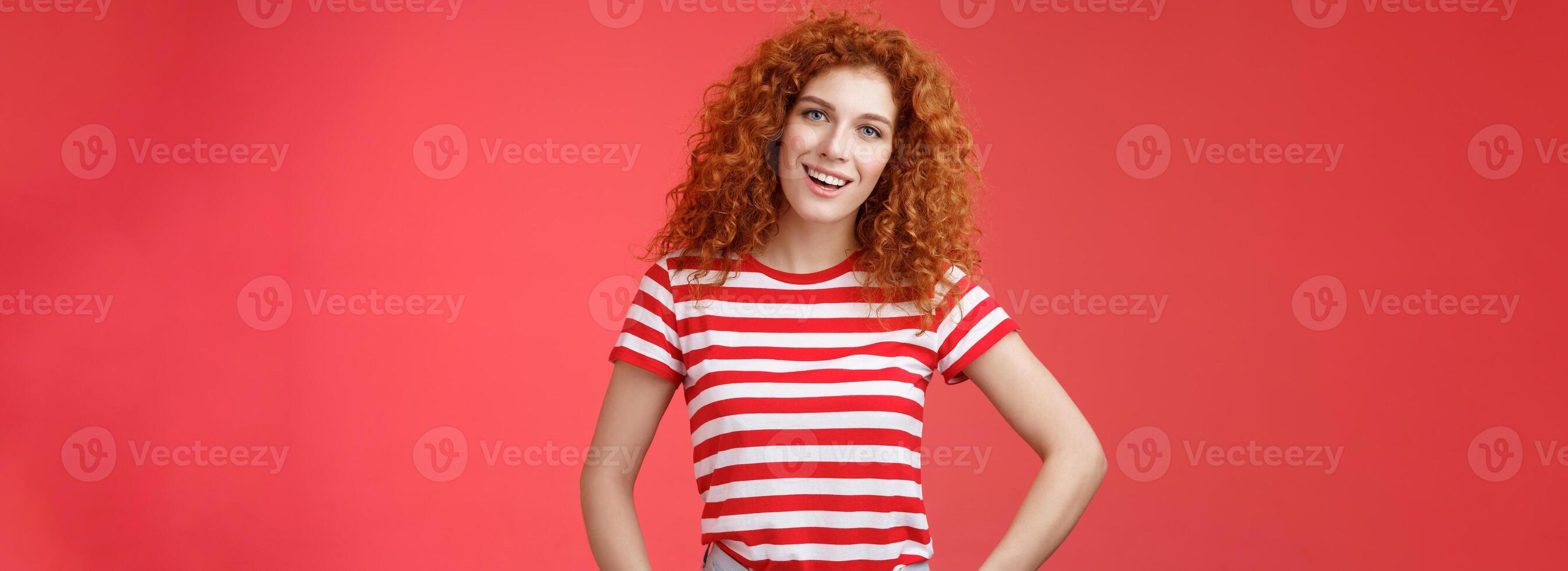 How hanging. Friendly carefree redhead curly-haired relaxed outgoing woman speaking casually entertained happy mood hold hands jeans pockets tilt head intrigued, curiously look camera photo