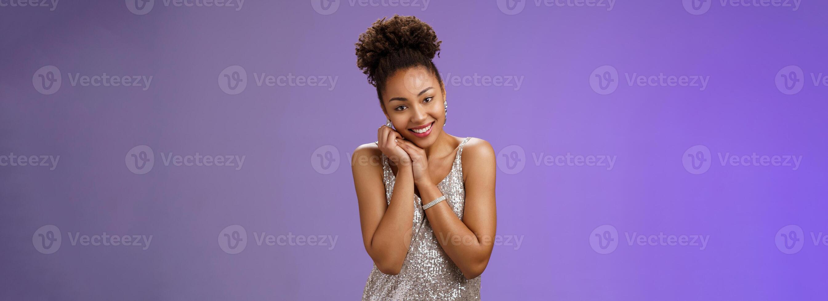 Touched romantic cute tender african-american girl lean palms smiling delighted receive heartwarming gesture passionately look camera glancing gladly grateful nice moving gift, blue background photo