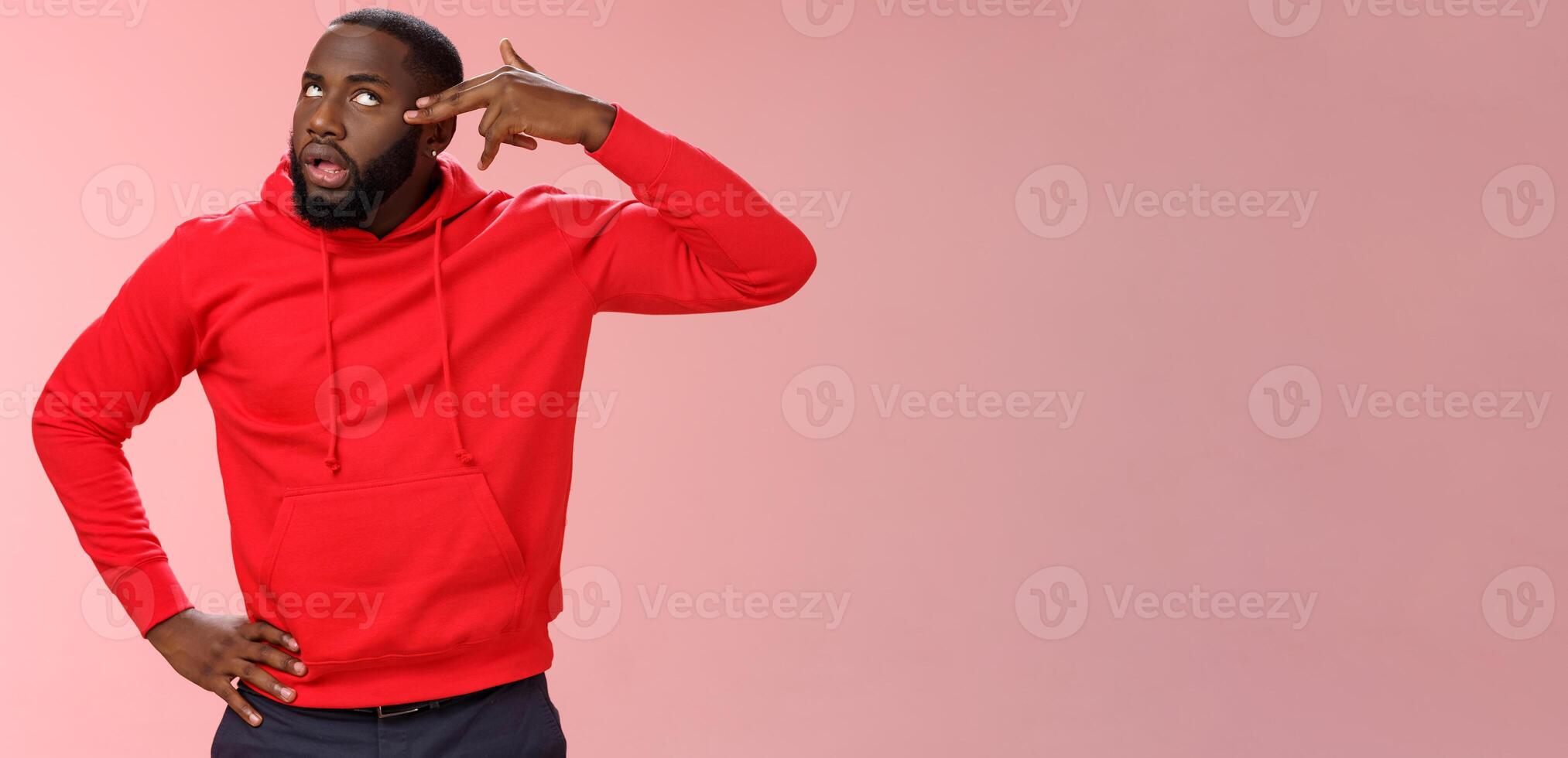 Guy showing finger pistol near head wanna shoot himself boredom annoyance acting ignorant roll eyelids commiting suicide after boring uninteresting lecture, standing irritated pink background photo