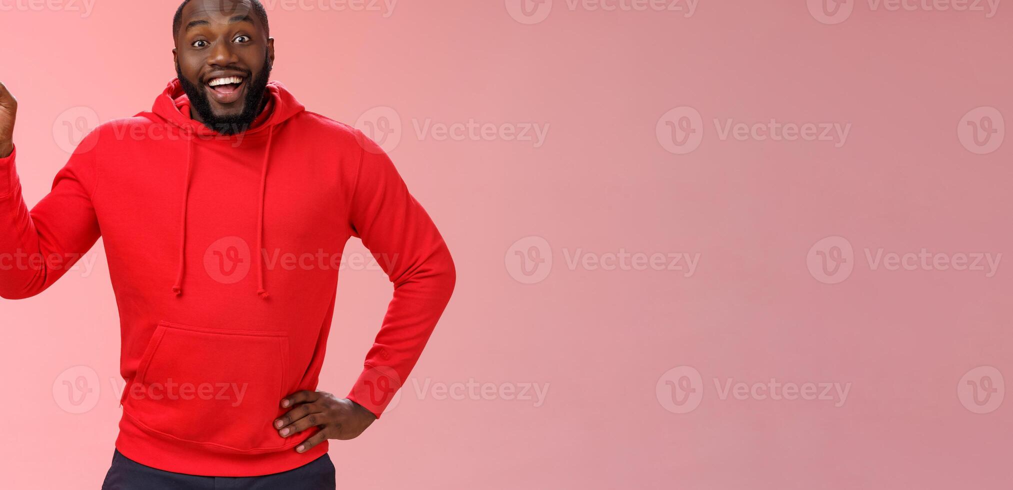 Enthusiastic happy good-looking young black guy beard pointing upper left corner smiling approval like curious about interesting item sale ask question excited impressed, standing pink background photo