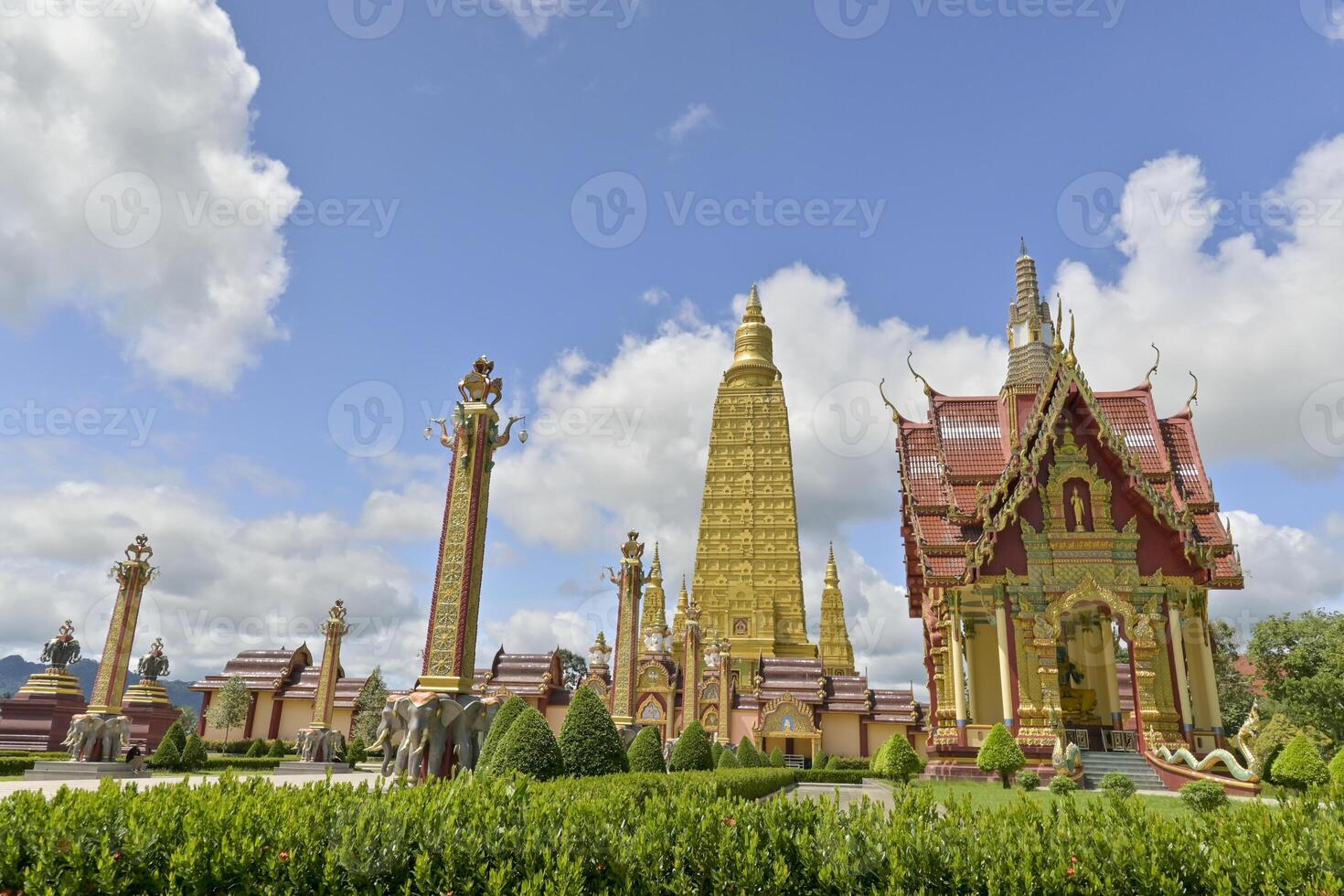 Wat Mahathat Wachiramongkhon or Wat Bang Thong, Krabi Province, Thailand. Beautiful scenery with exterior architecture in the garden of buddhist temple under cloudy blue sky during summer. photo