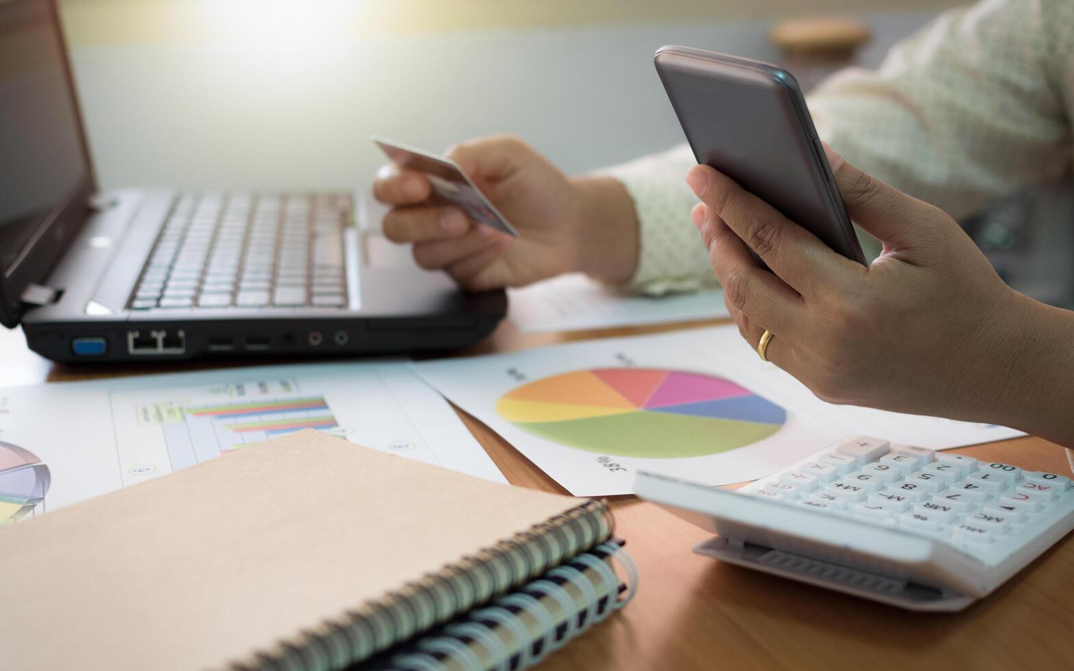 Businesswoman using mobile phone to online payment by credit card. photo