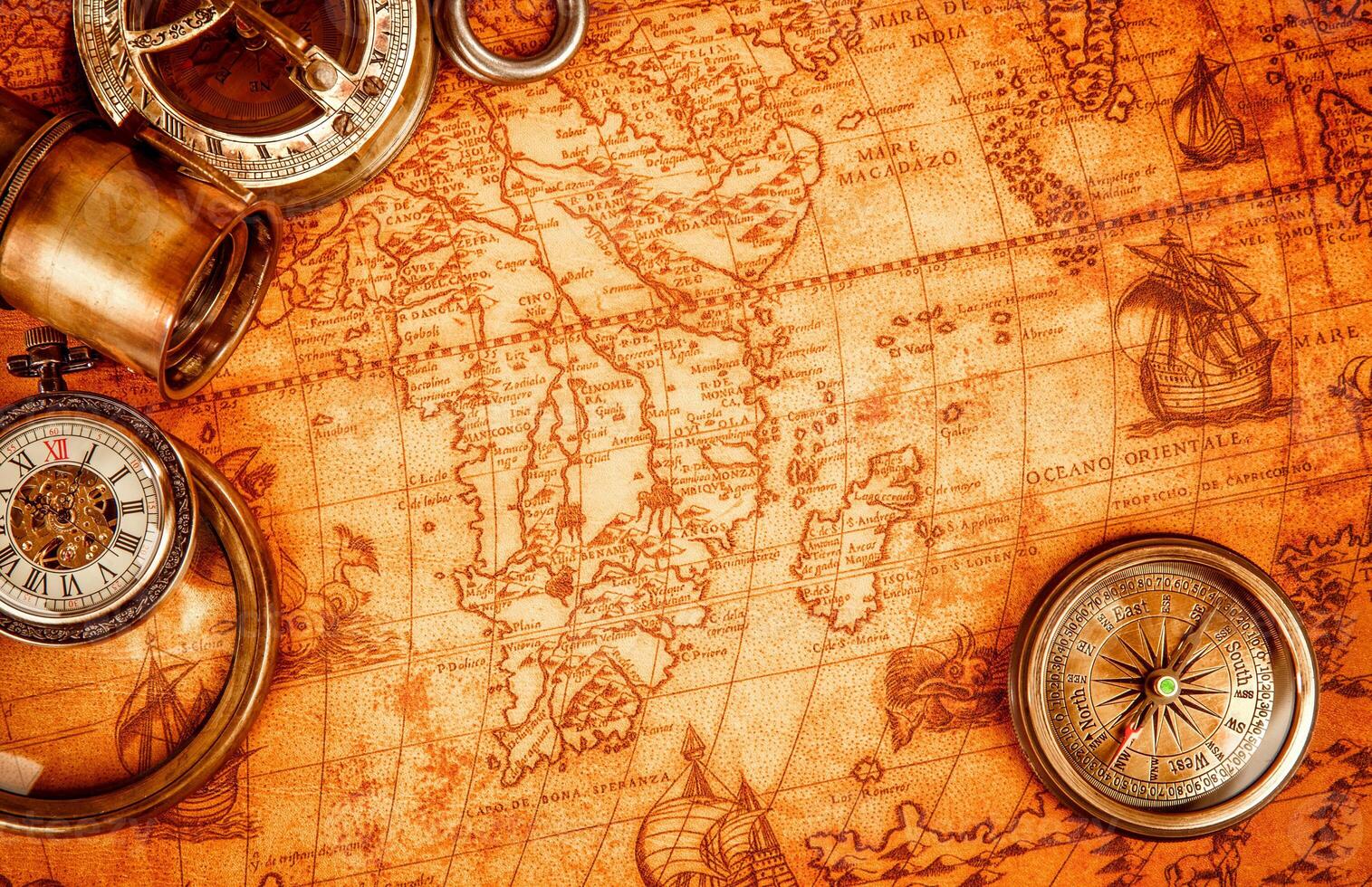 Vintage magnifying glass lies on an ancient world map photo