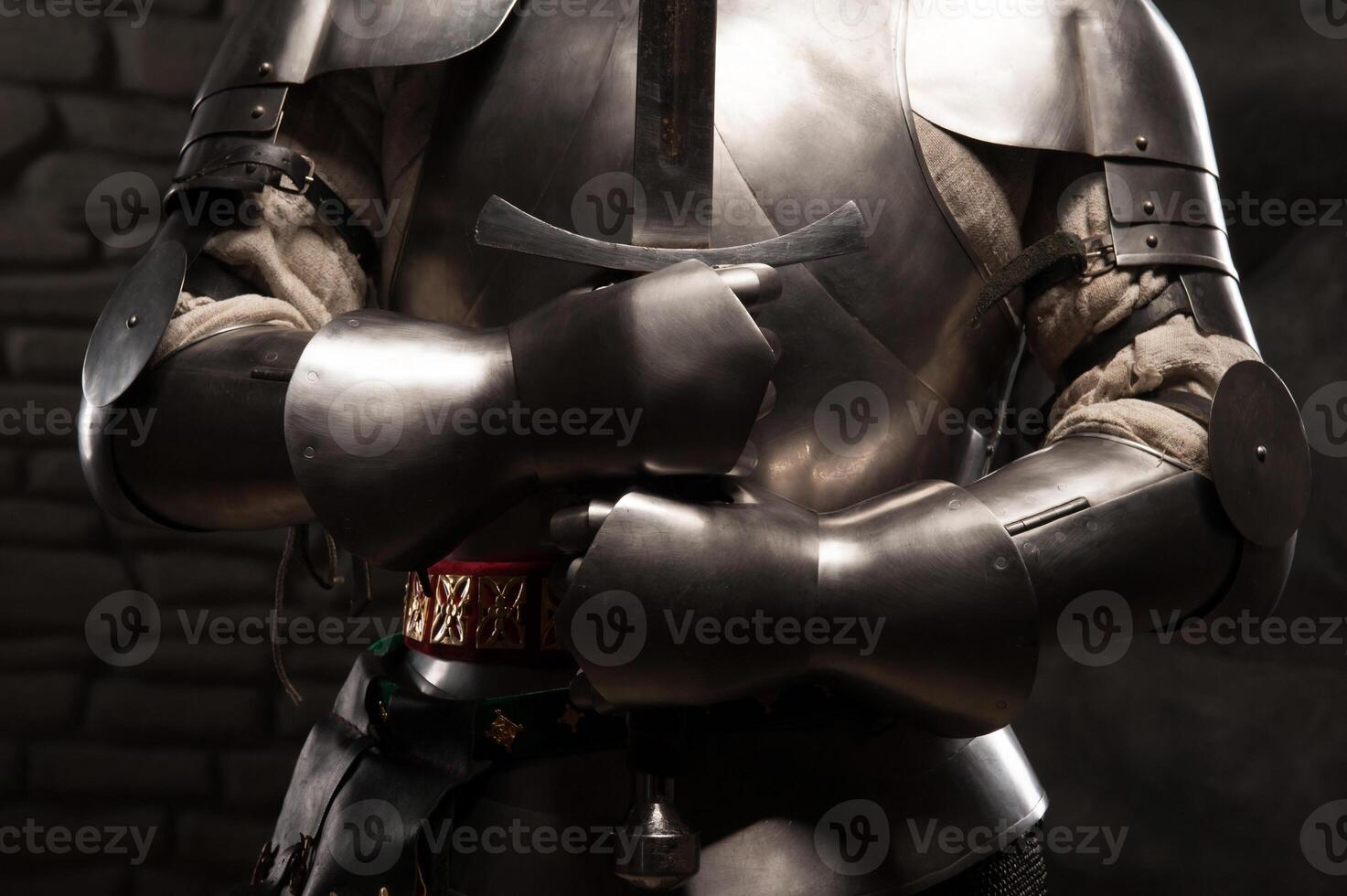 Closeup portrait of medieval knight in armor holding a sword photo