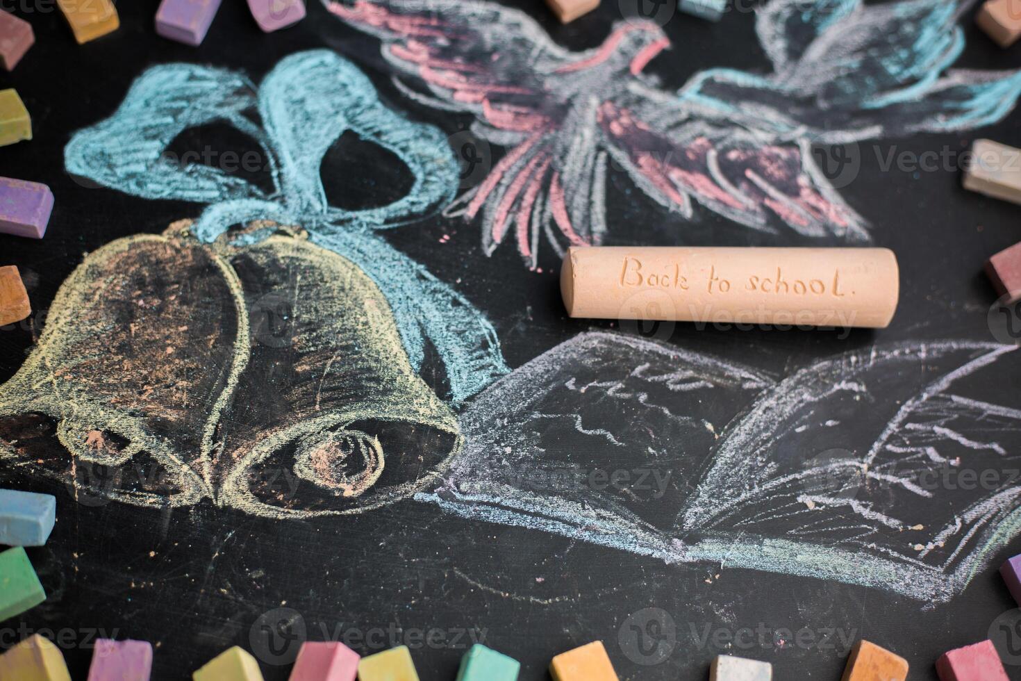 School concept on blackboard chalk drawn bells and notebook photo