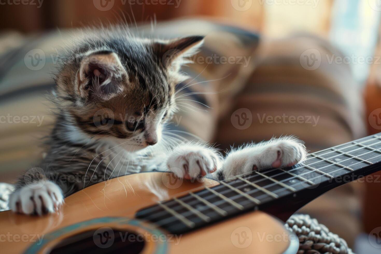 Playful Kitten Joyfully Interacting with a Guitar, Showcasing Adorable and Amusing Moments photo