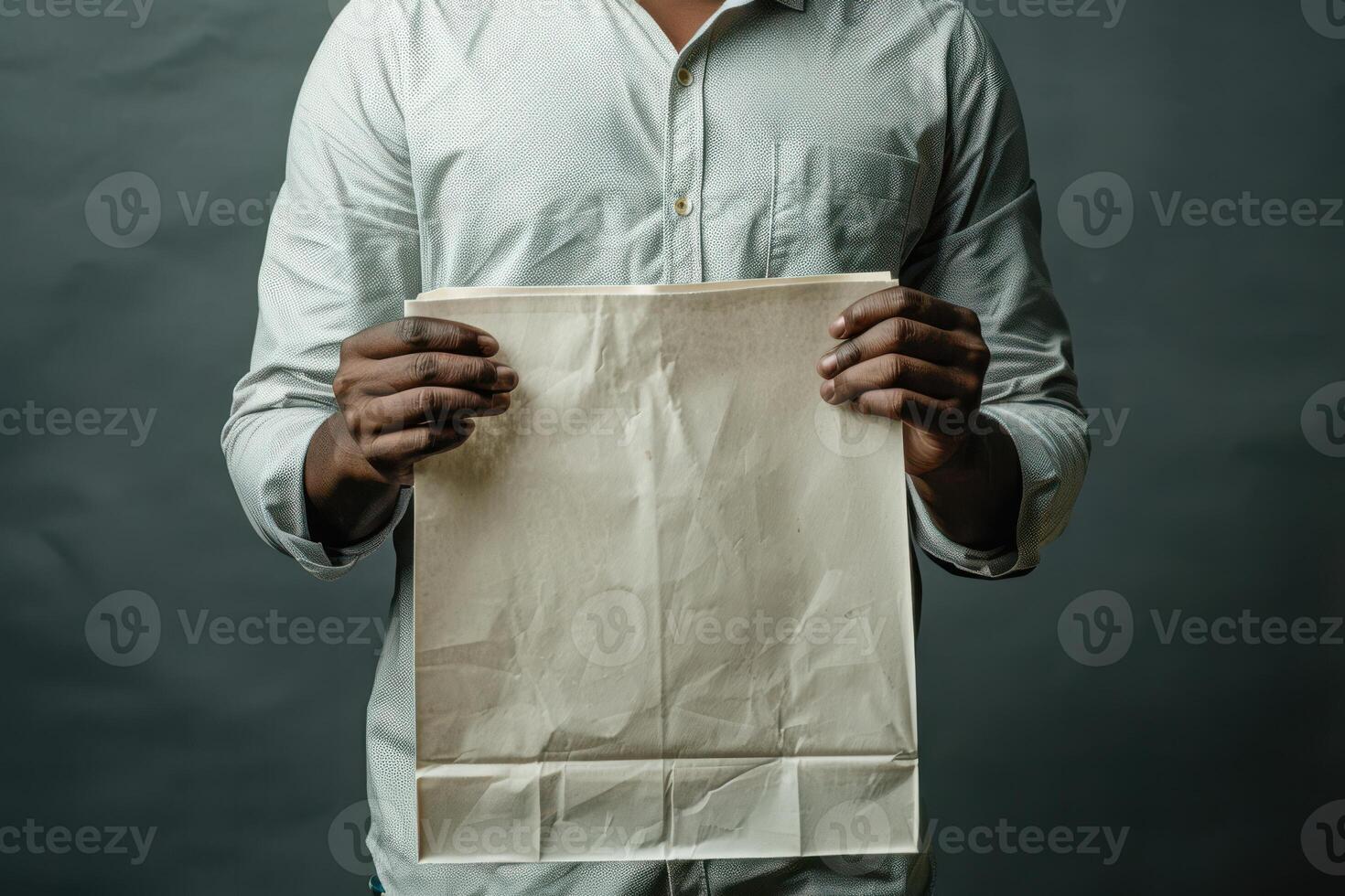 Man Holding a Blank Shopping Bag, Ready for Retail Purchases with a Simple and Casual Design photo