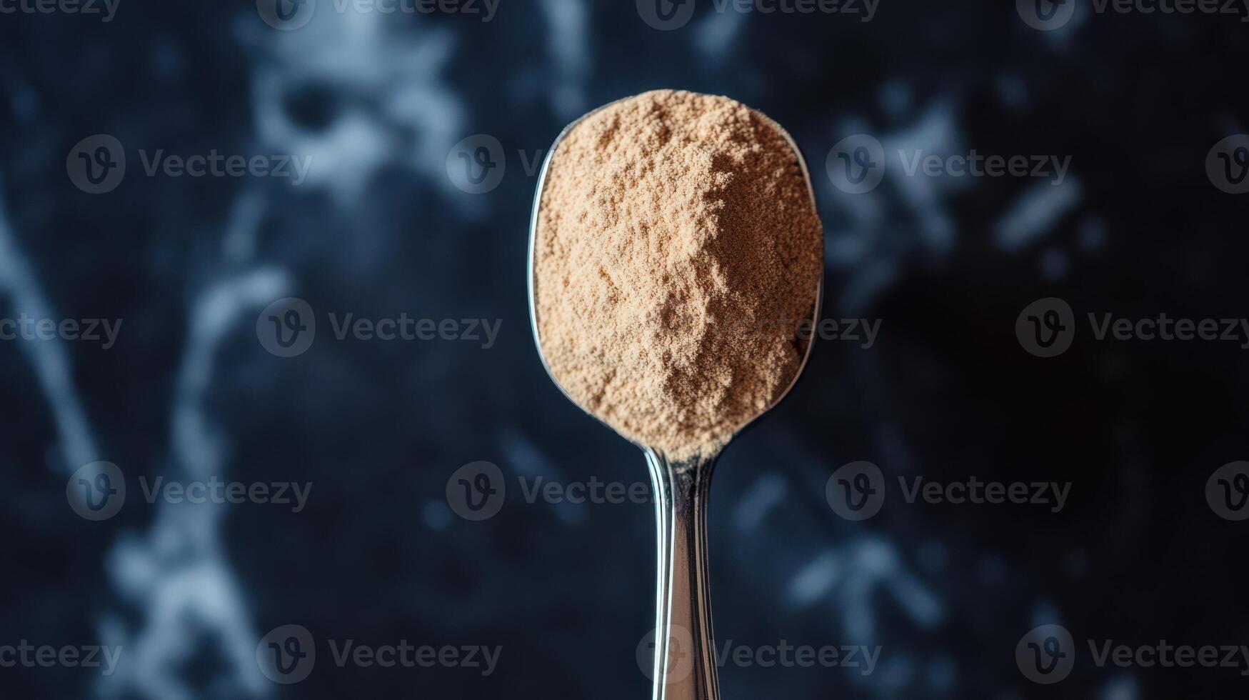 Spoon with a serving of BCAA beta-glucan anabolic whey protein powder. photo